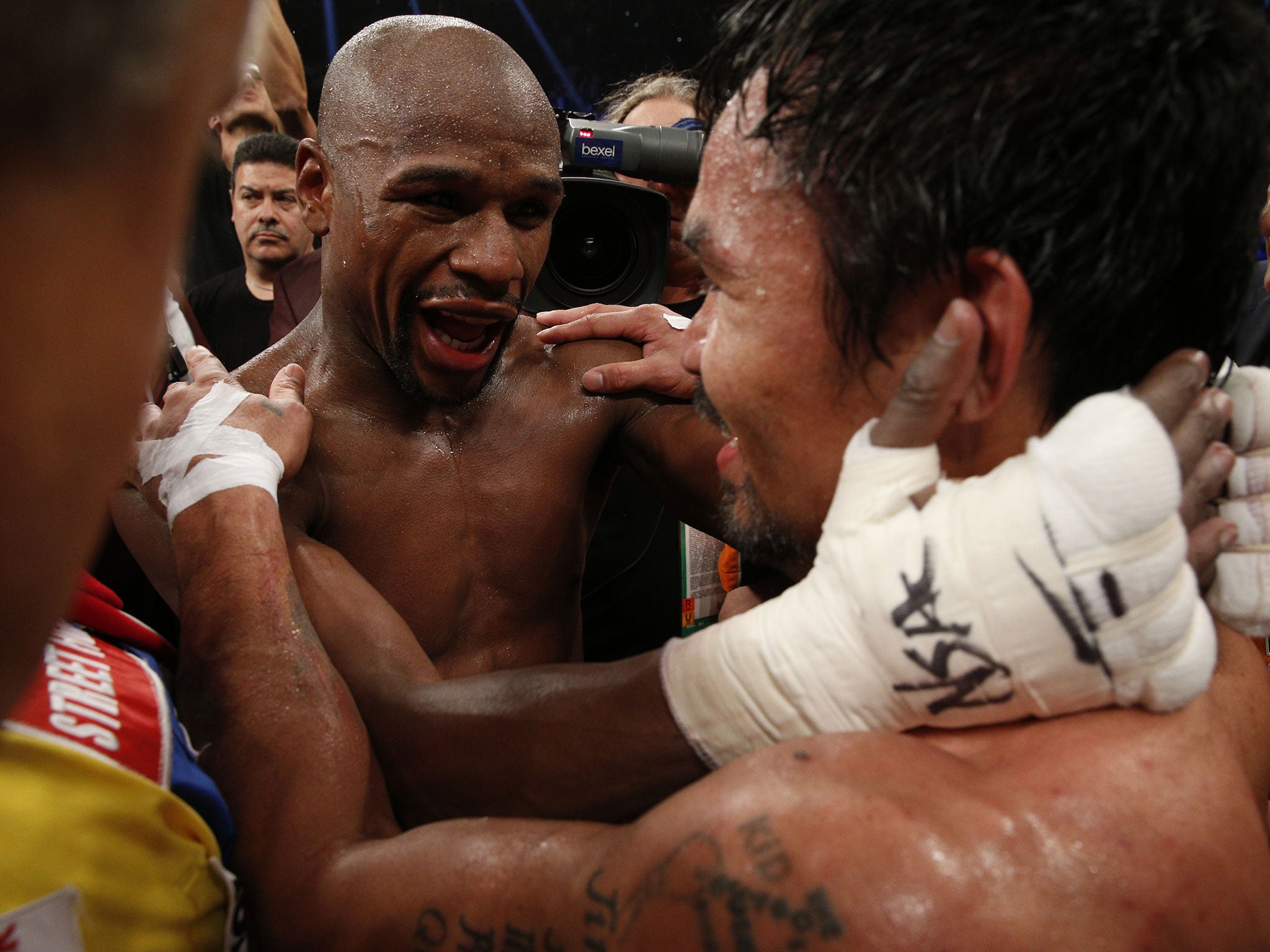 Mayweather and Pacquiao embrace at the final bell