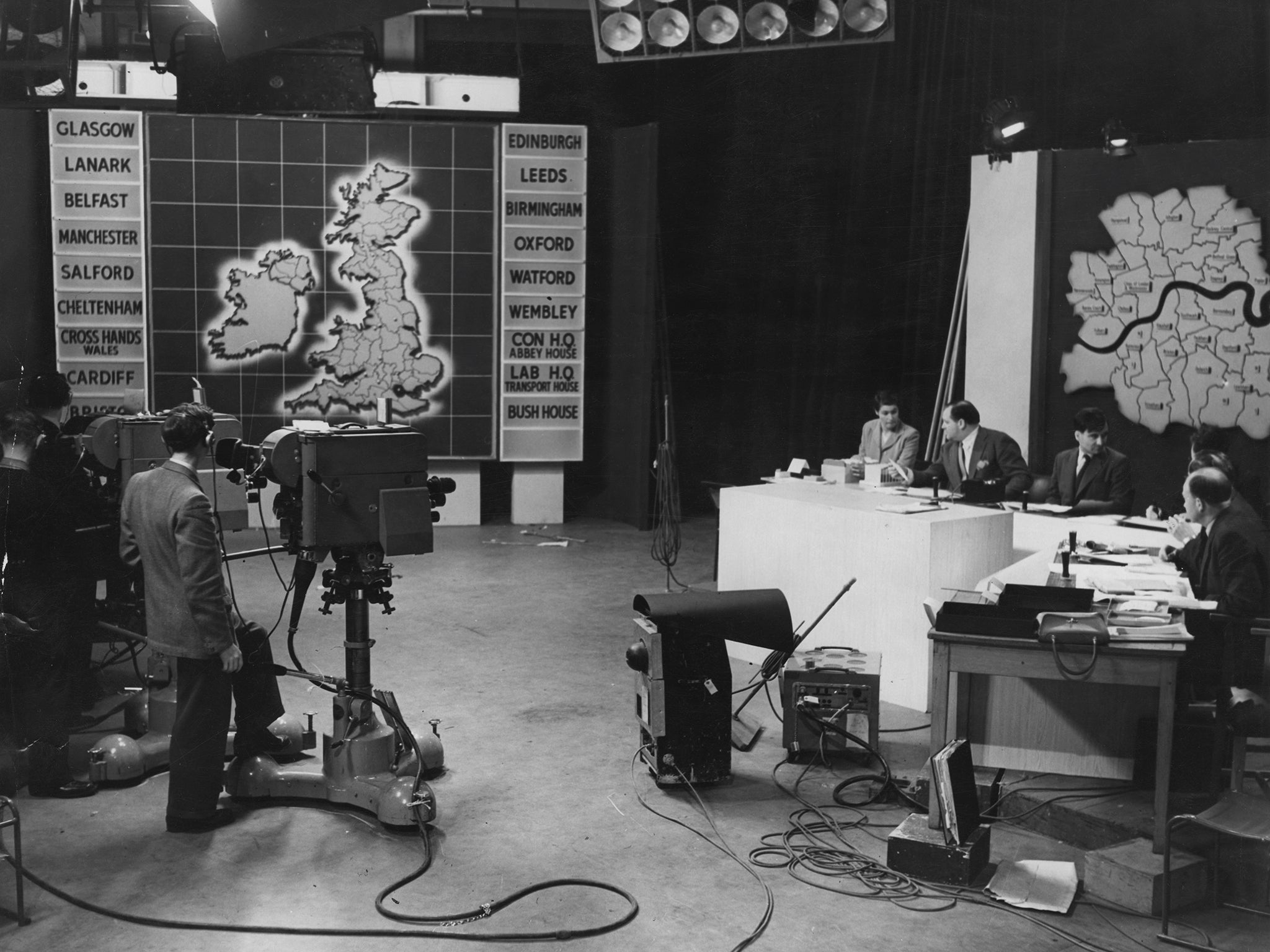 English journalist and broadcaster Richard Dimbleby prepares with statisticians during rehearsals for the BBC's General Election live coverage in 1955