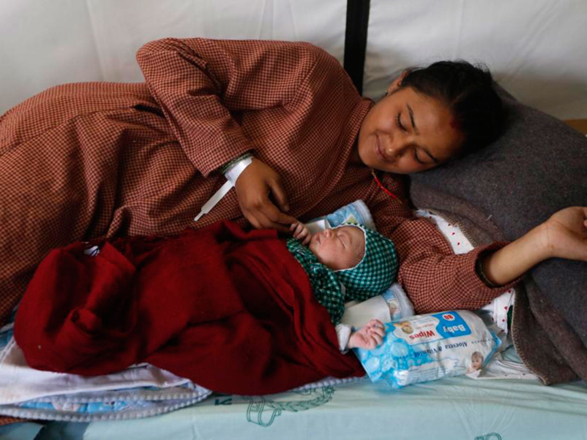 New mother Lata Chand lies with new baby born on Friday (AP)