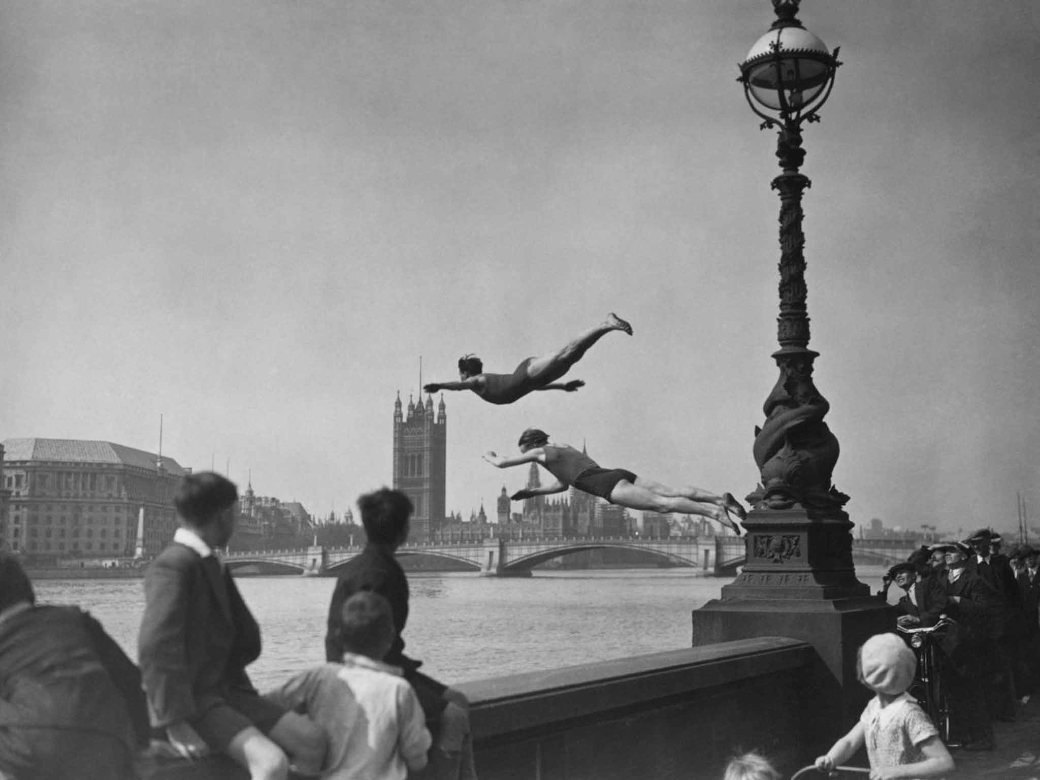 A capital idea: two divers jumping off the Embankment into the River Thames in London, near Westminster Bridge