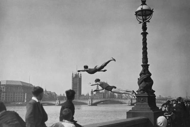 A capital idea: two divers jumping off the Embankment into the River Thames in London, near Westminster Bridge