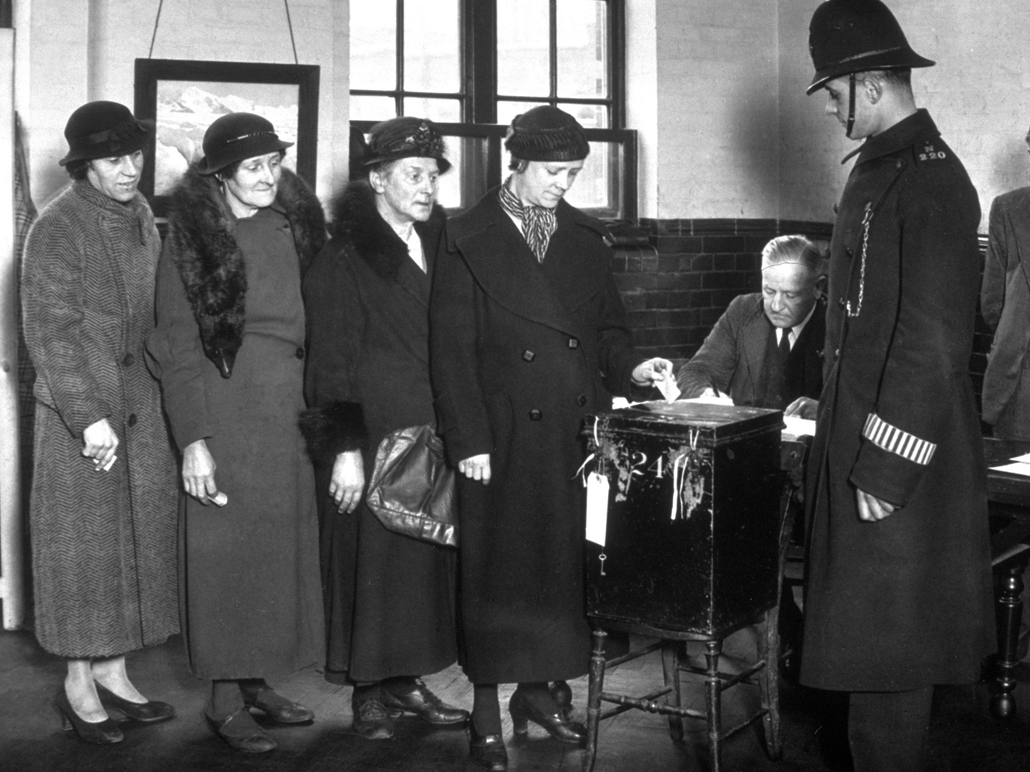 Voters queuing up to vote at a polling station in St. Pancras, London in 1937