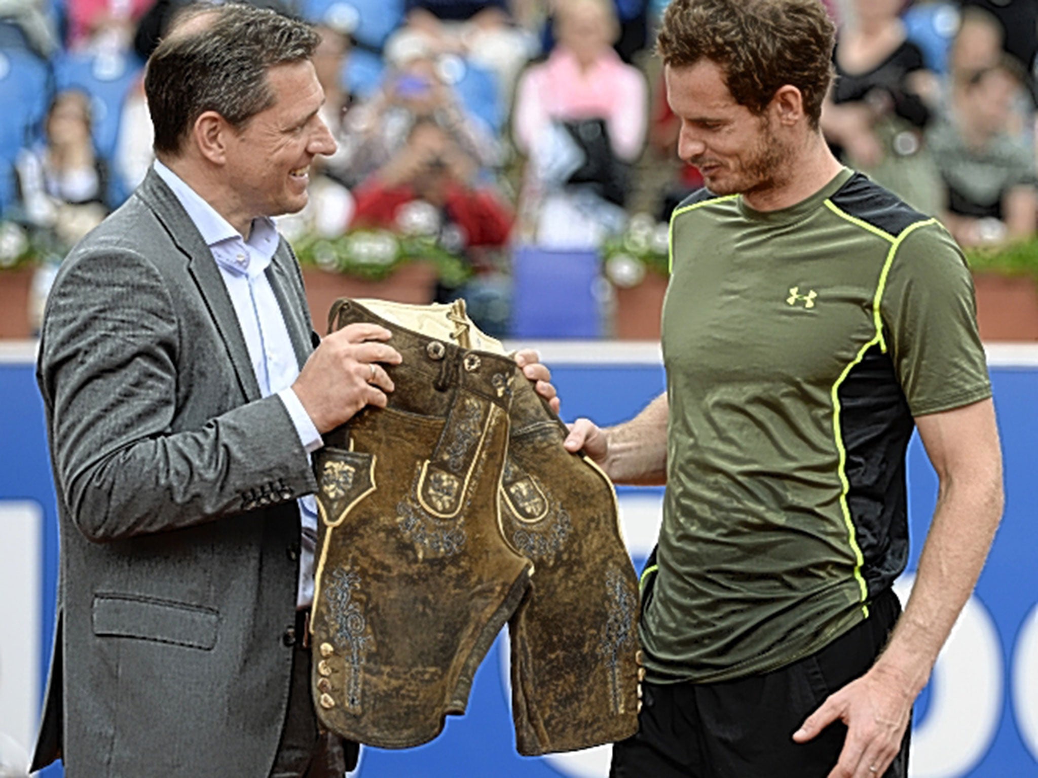 Andy Murray is presented with a pair of lederhosen after beating Philipp Kohlschreiber