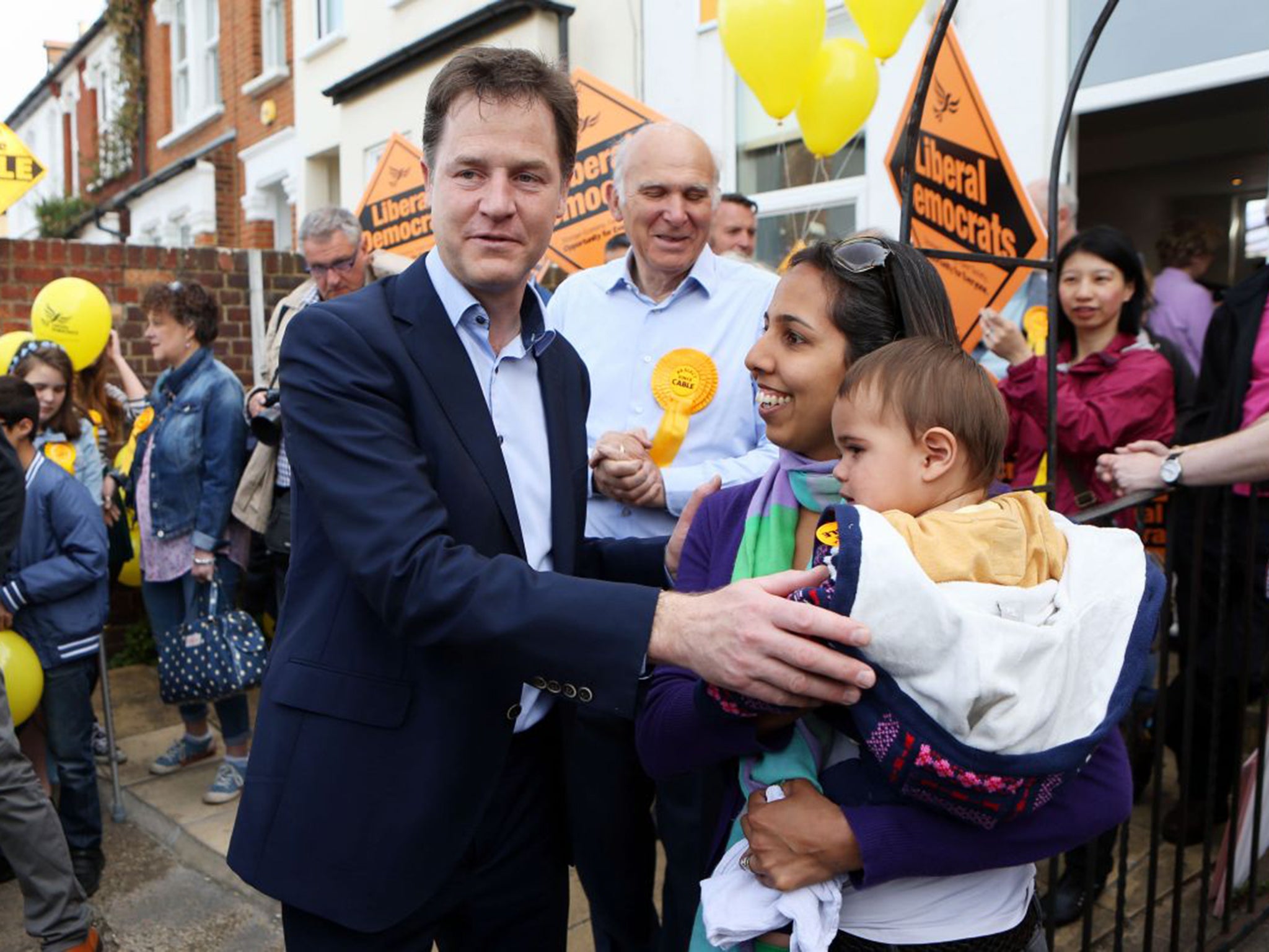 Nick Clegg meets supporter Munira Wilson and her daughter Zarina as the Business Secretary Vince Cable looks on during a visit to Twickenham, south-west London, on Monday