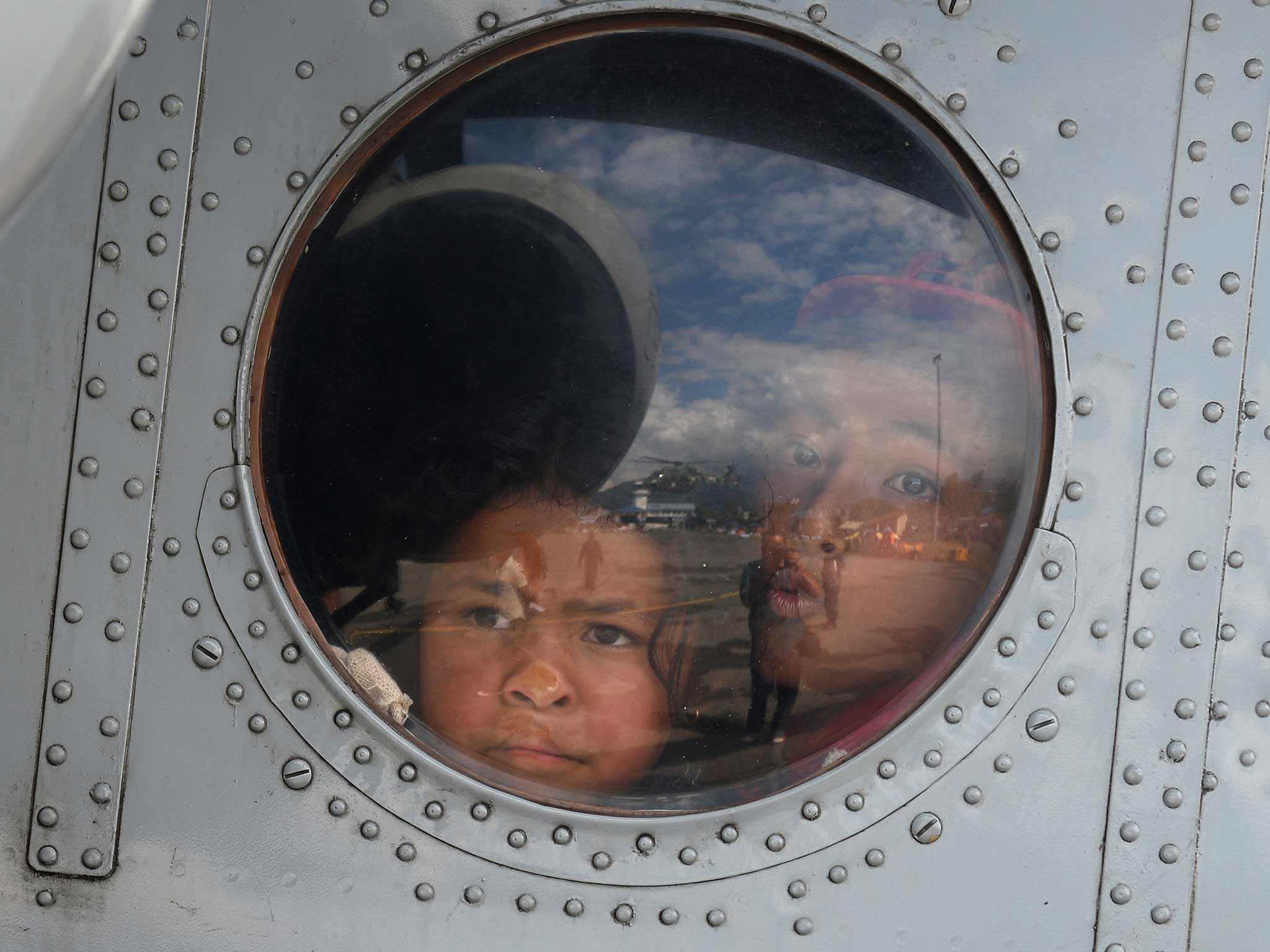 Nepalese children sit inside an Indian Air Force chopper after they were rescued from an earthquake-hit village