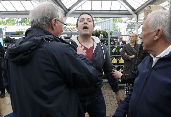 A Scottish National Party heckler shouts during an election rally by Britain's Prime Minister David Cameron at Squires garden centre in Twickenham, London,