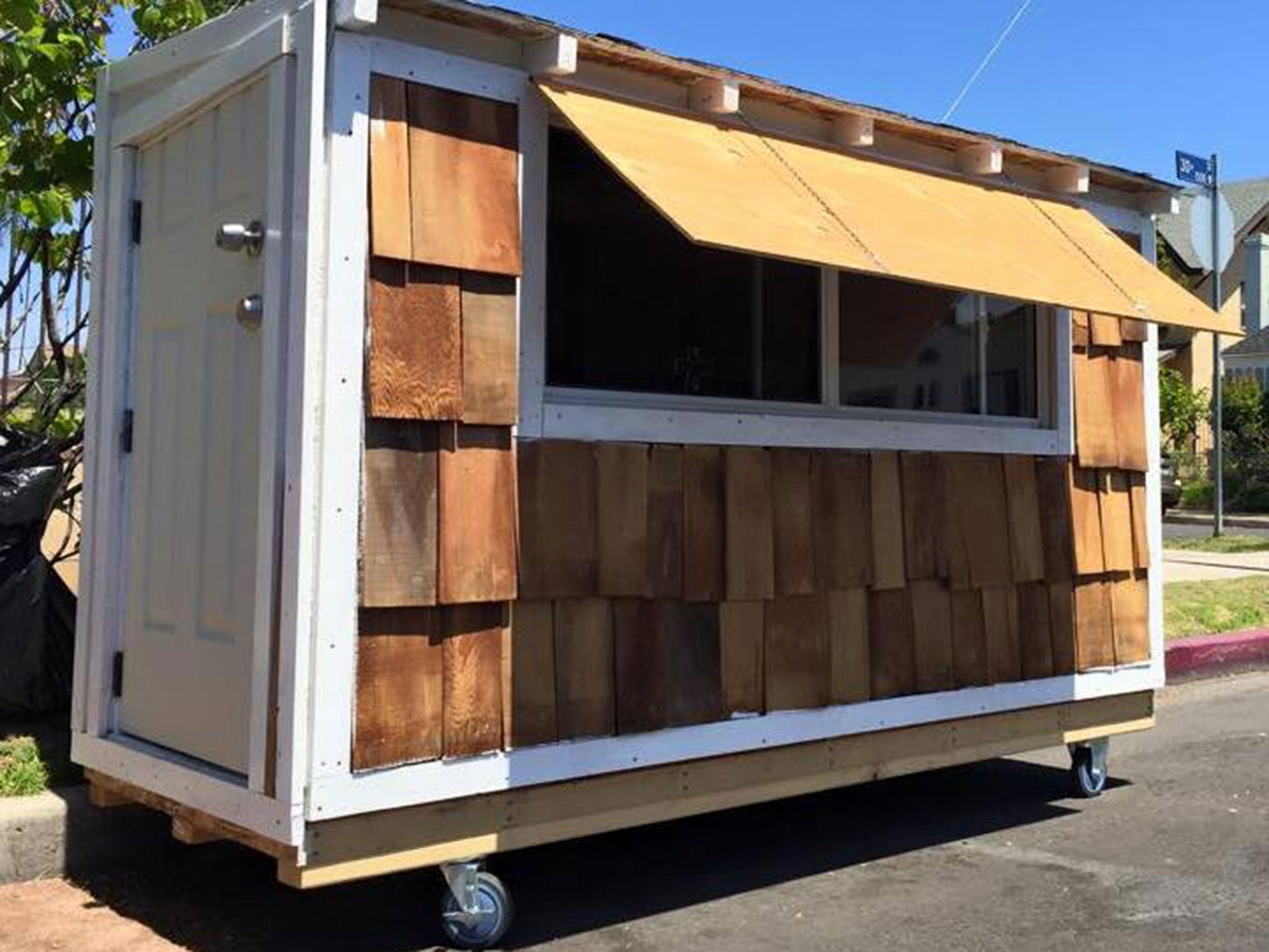 Elvis Summers with the house he built for homeless woman Irene McGee