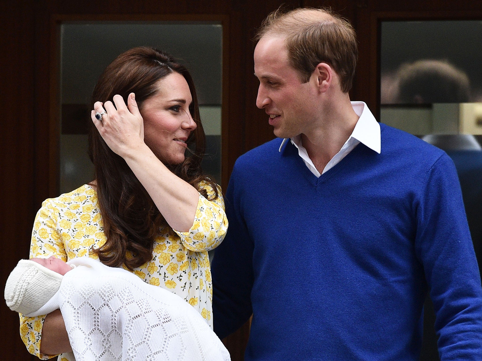 Prince William, Duke of Cambridge looks towards his wife Catherine, Duchess of Cambridge, as they show their newly-born daughter, their second child, to the media outside the Lindo Wing at St Mary's Hospital in central London. The Duchess of Cambridge wa