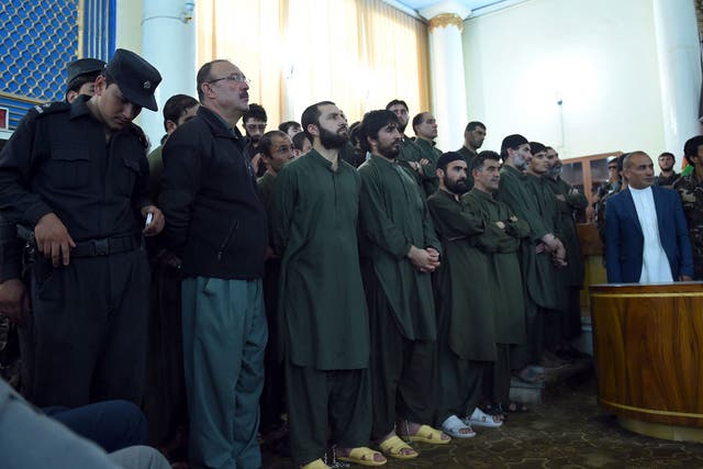 Suspects stand before a judge during a primary court trial in Kabul, on charges relating to the mob killing of a 27-year-old Afghan woman