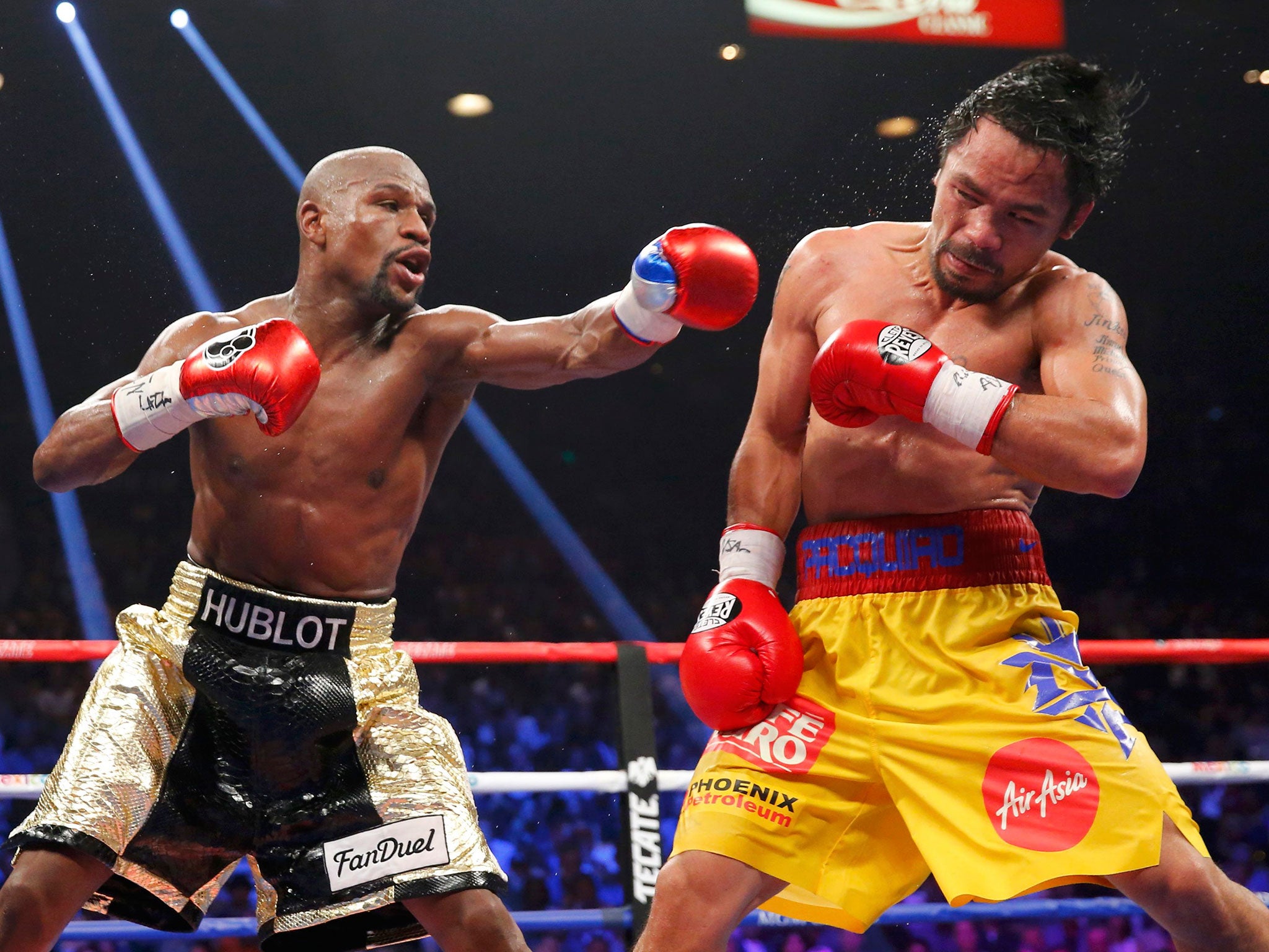 Floyd Mayweather, Jr. of the U.S. lands a left to the face of Manny Pacquiao of the Philippines (R) in the 11th round during their welterweight WBO, WBC and WBA (Super) title fight in Las Vegas, Nevada