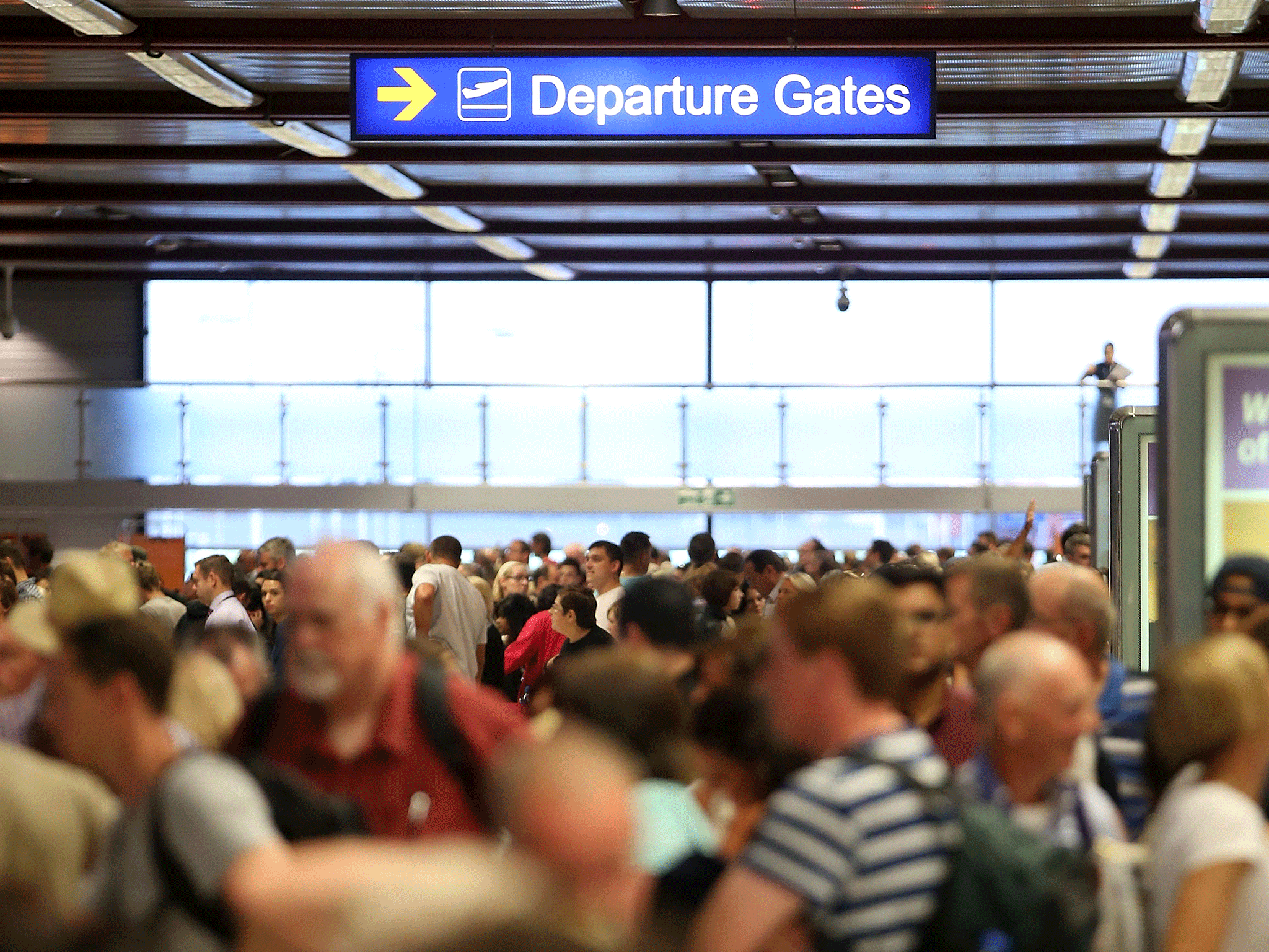 Crowds wait at London Luton Airport in September 2014