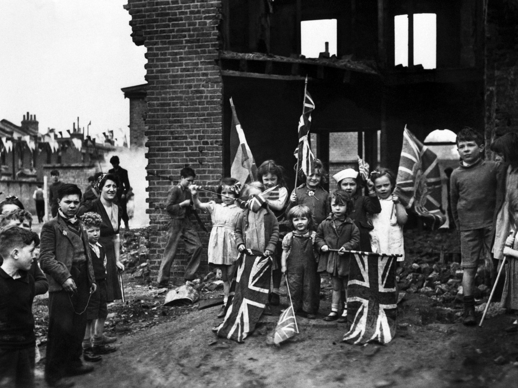 Flagging enthusiasm: young Londoners do their best to join in the celebrations despite the destruction of their homes in Battersea, south London