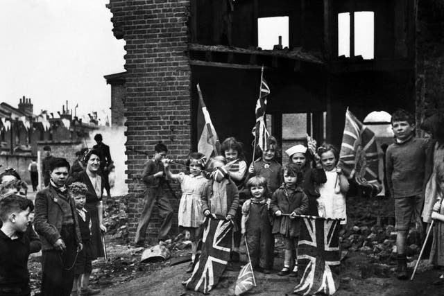 Flagging enthusiasm: young Londoners do their best to join in the celebrations despite the destruction of their homes in Battersea, south London