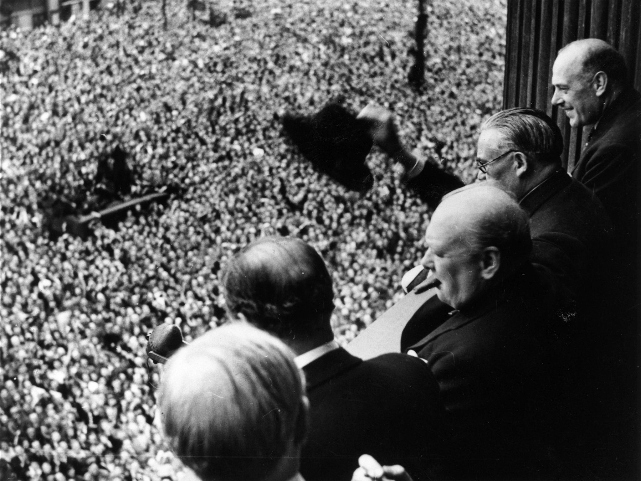 Churchill waves to the crowds in Whitehall (Getty)