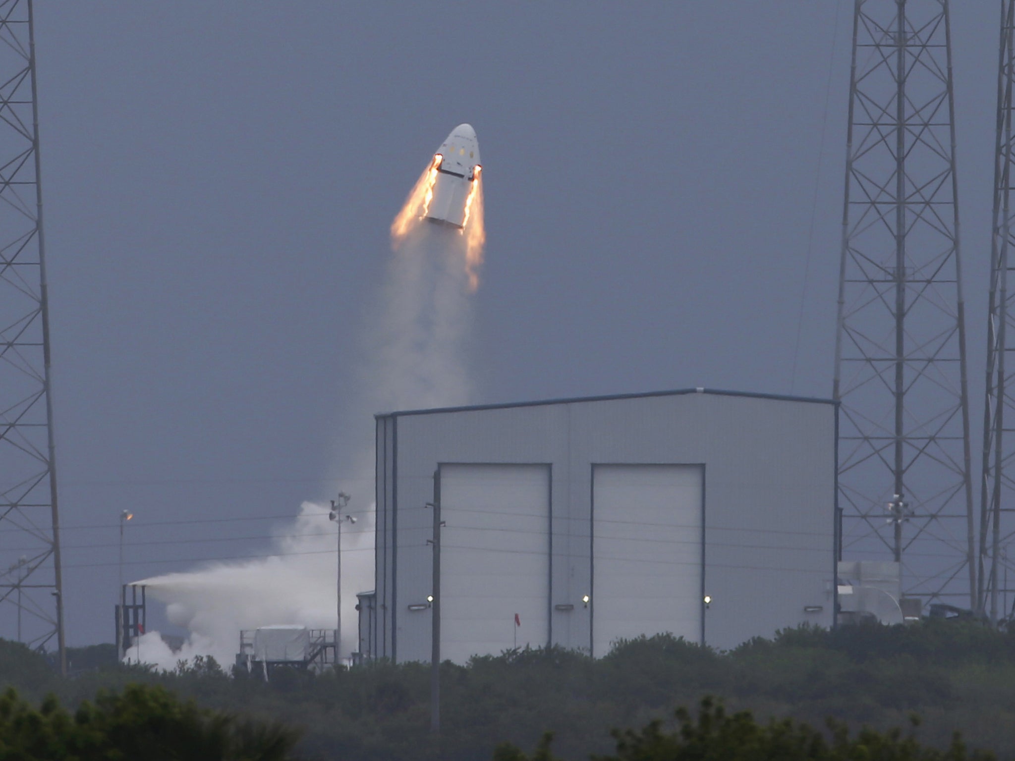 The unmanned SpaceX Crew Dragon lifts off from launch pad 40 during a Pad Abort Test at the Cape Canaveral Air Force Station in Cape Canaveral, Florida May 6, 2015