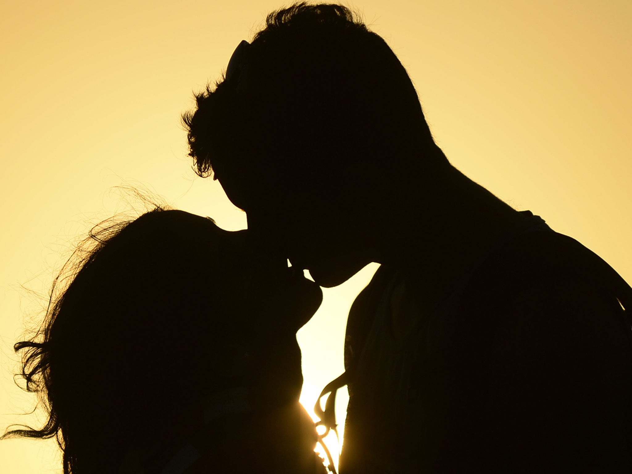 A couple kiss near the shore of El Yaque Beach, Nueva Esparta state, Margarita Island, Venezuela on January 31, 2014.
