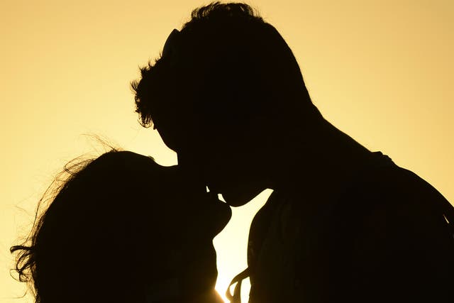 A couple kiss near the shore of El Yaque Beach, Nueva Esparta state, Margarita Island, Venezuela on January 31, 2014. 