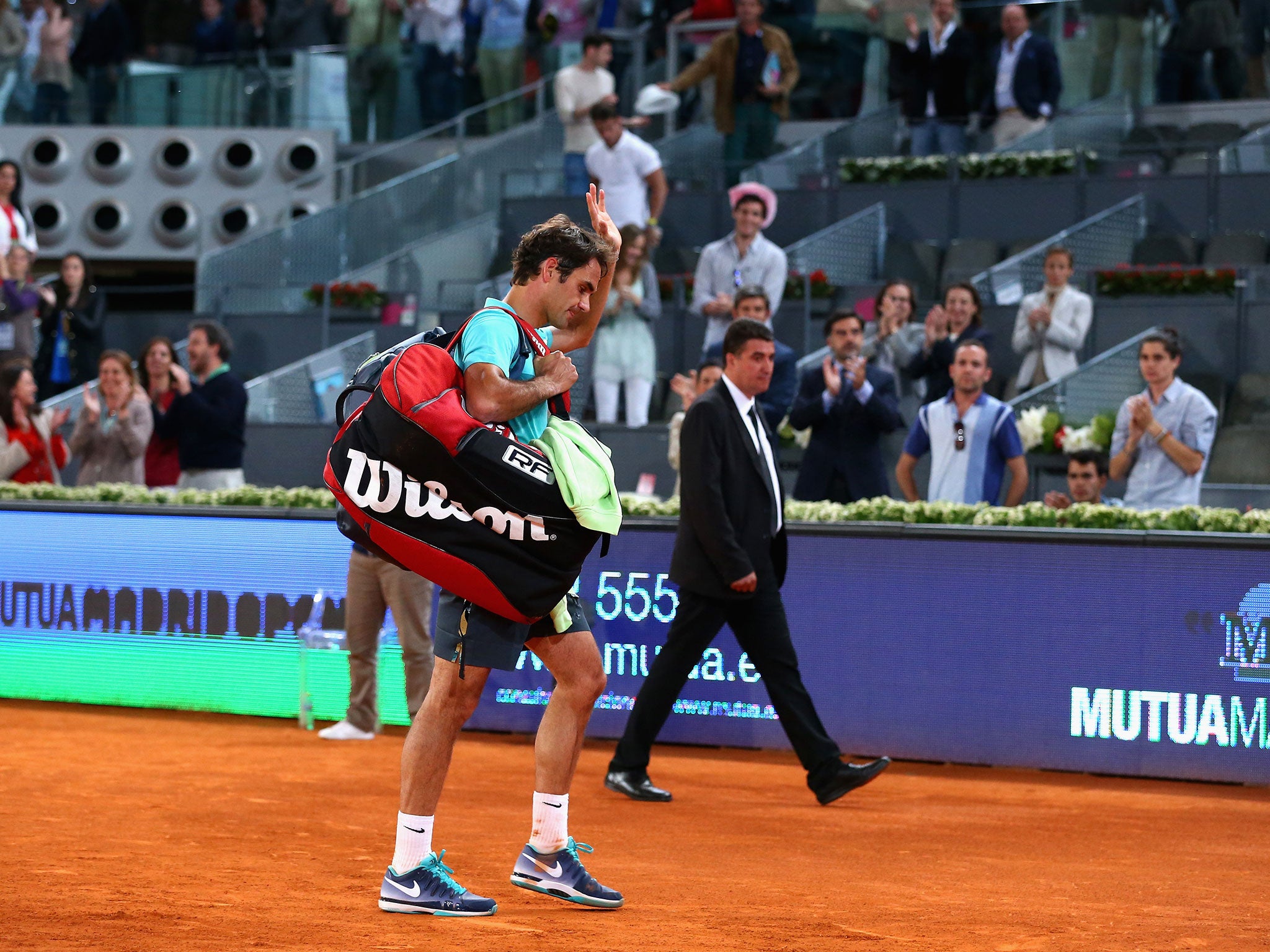Roger Federer waves to fans after suffering defeat to Nick Kyrgios