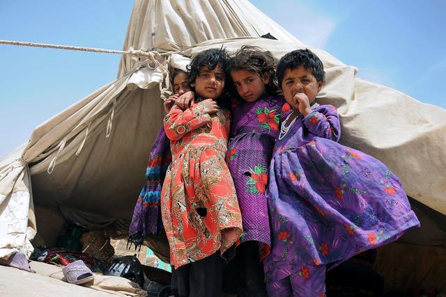 Young Afghans displaced from their homes in a camp in Mazar-i-Sharif