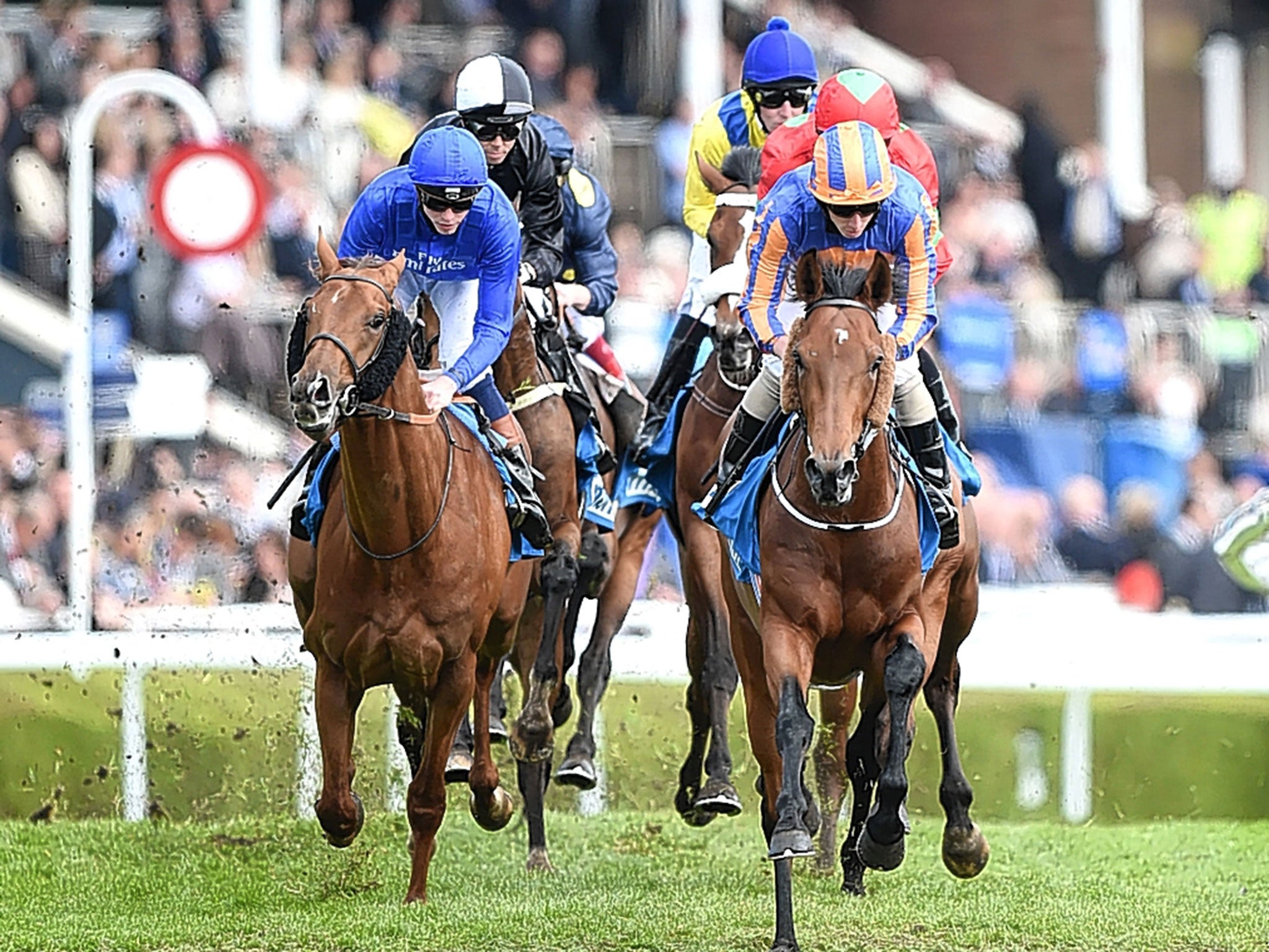 Hans Holbein (right) copes well with the softened ground in the Chester Vase under Ryan Moore on Thursday