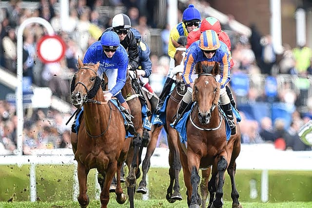 Hans Holbein (right) copes well with the softened ground in the Chester Vase under Ryan Moore on Thursday 