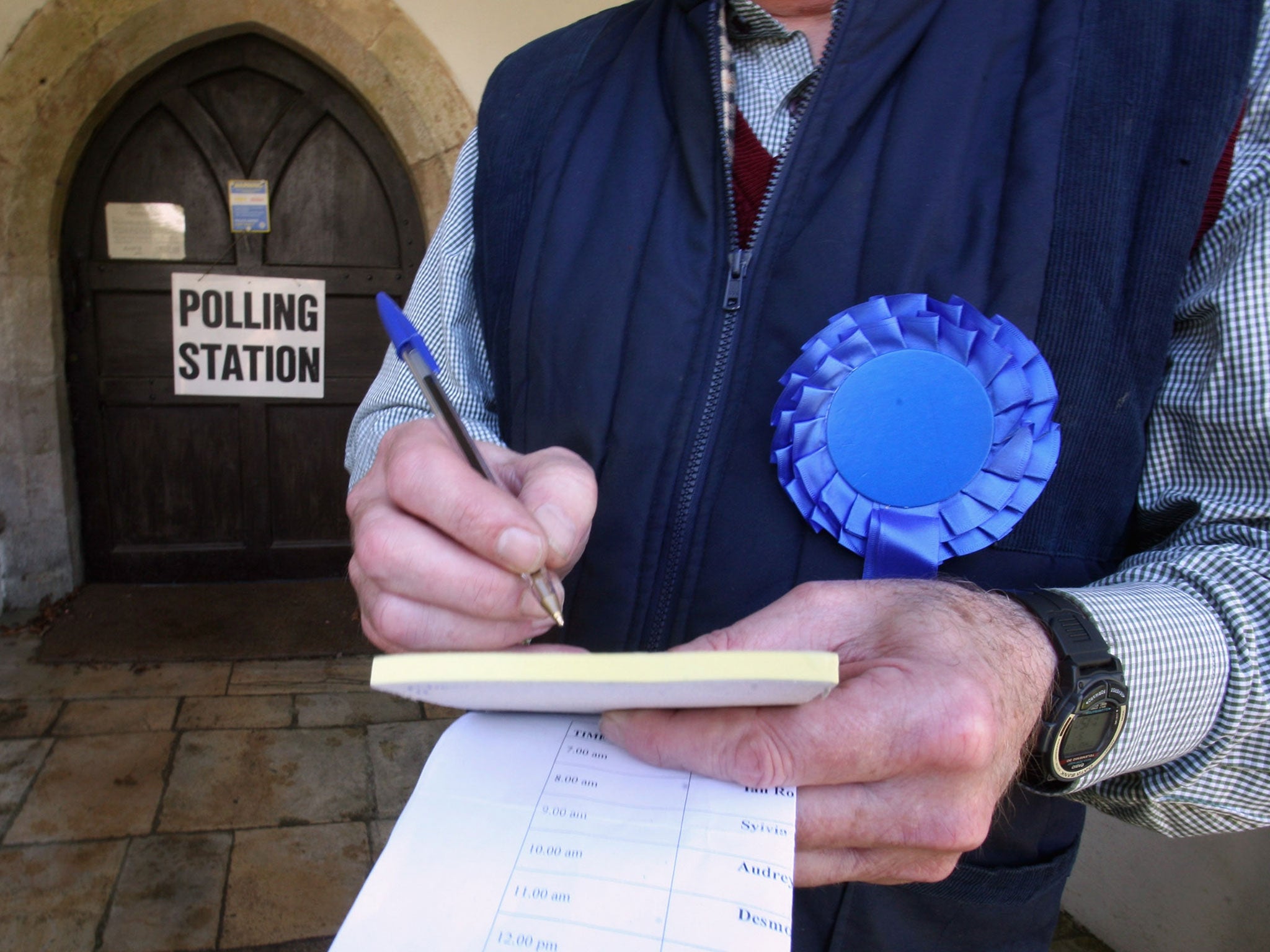 A teller collects data outside a polling station