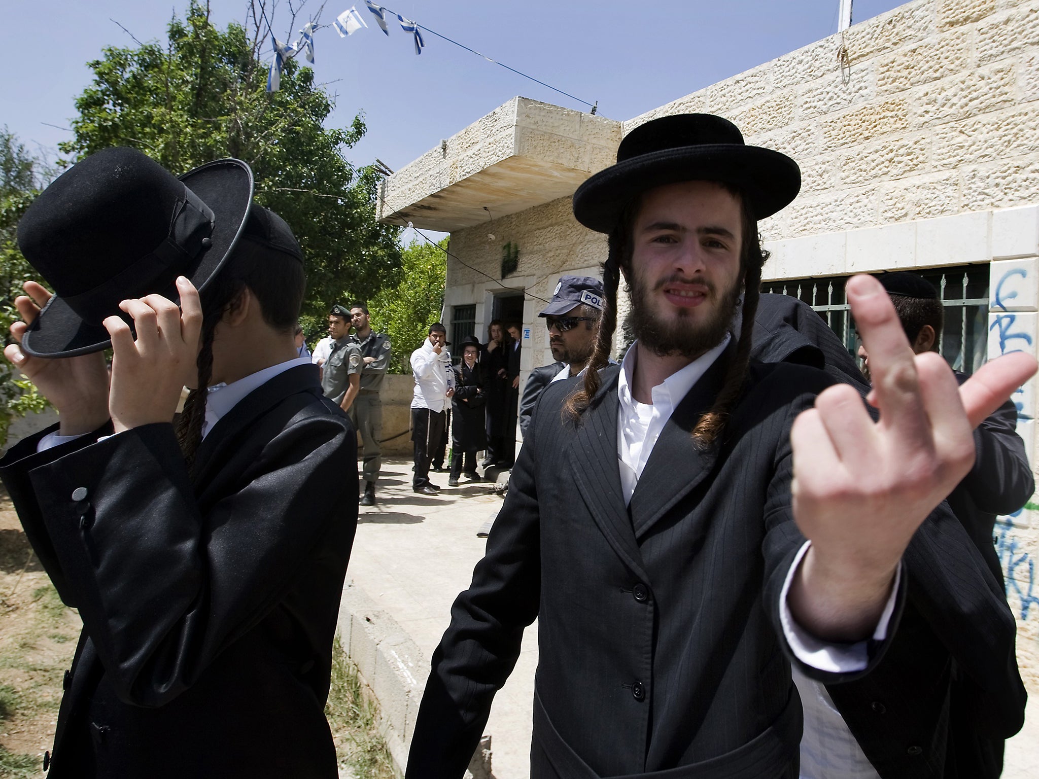 An Ultra-Orthodox Jewish man gestures as he stands outside the house of the Palestinian Kurd family who were evicted by Israeli settlers in east Jerusalem’s Arab quarter of Sheikh Jarrah