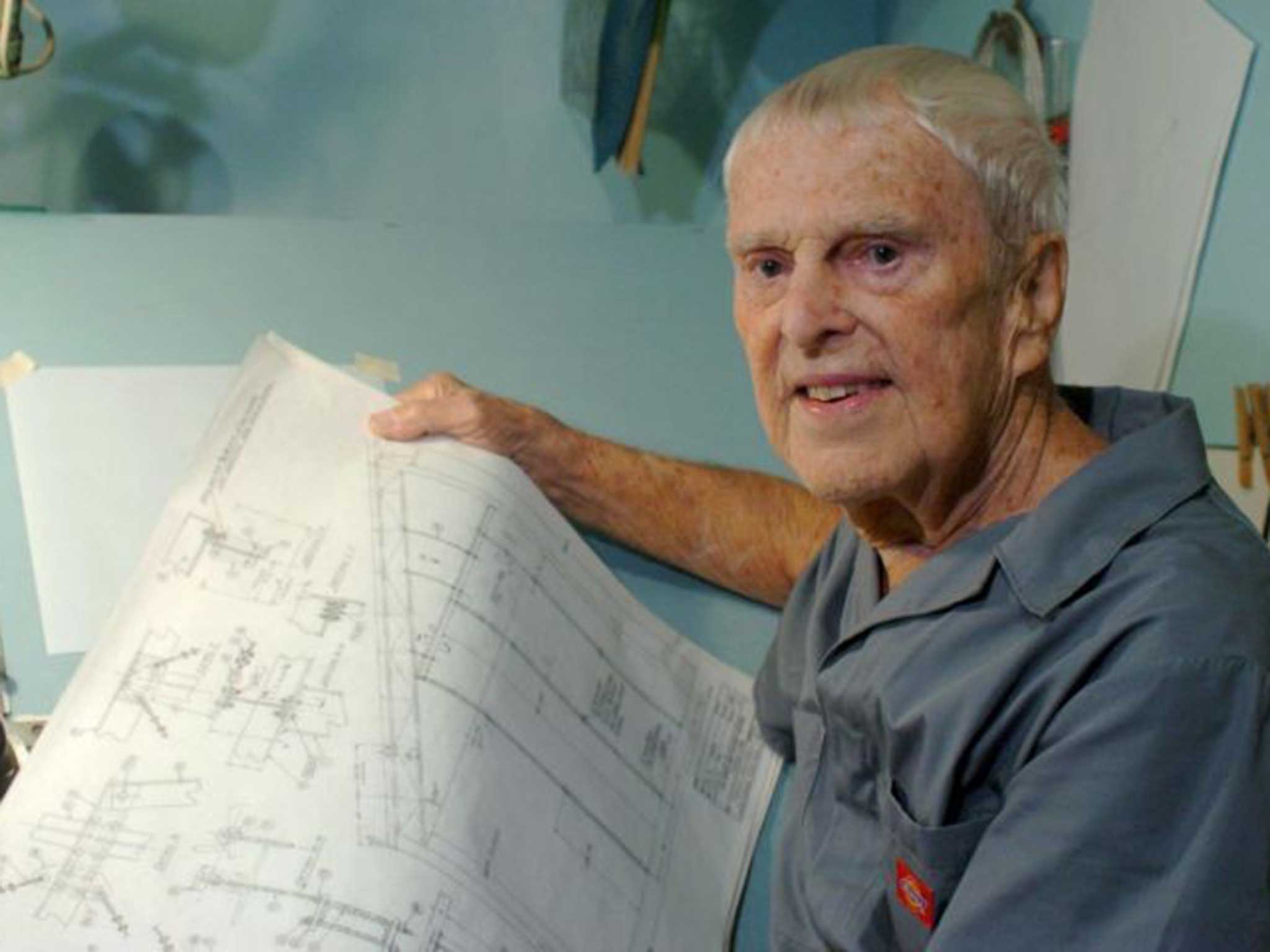 Holderer holds some technical drawings in his home shop behind his house in 2008