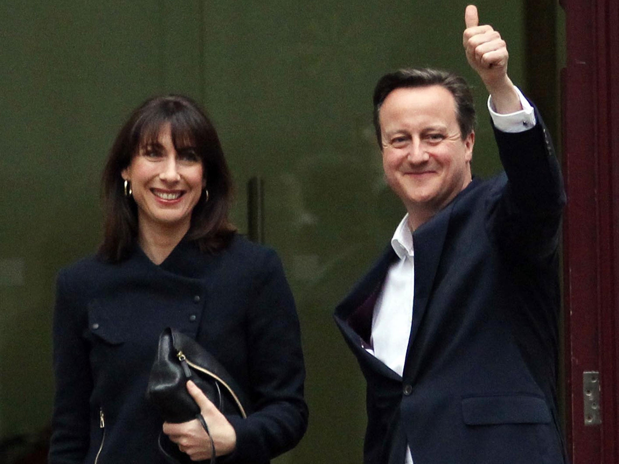 Prime Minister David Cameron and wife Samantha arrive at his Tory headquarters in central London after the General Election put his Conservative Party on the brink of securing an absolute majority in the House of Commons 