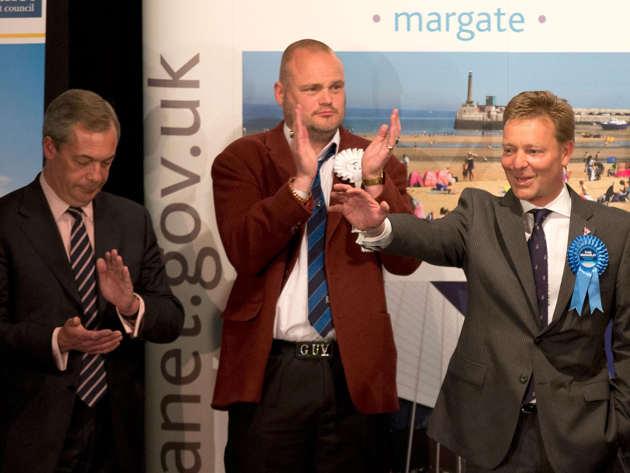 The Conservative Party's Craig Mackinlay, right, waves after winning the count for the South Thanet seat beside, from left, Nigel Farage the leader of the UK Independence Party (UKIP) and Al Murray a comedian who performs as "The Pub Landlord" at the Winter Gardens in Margate