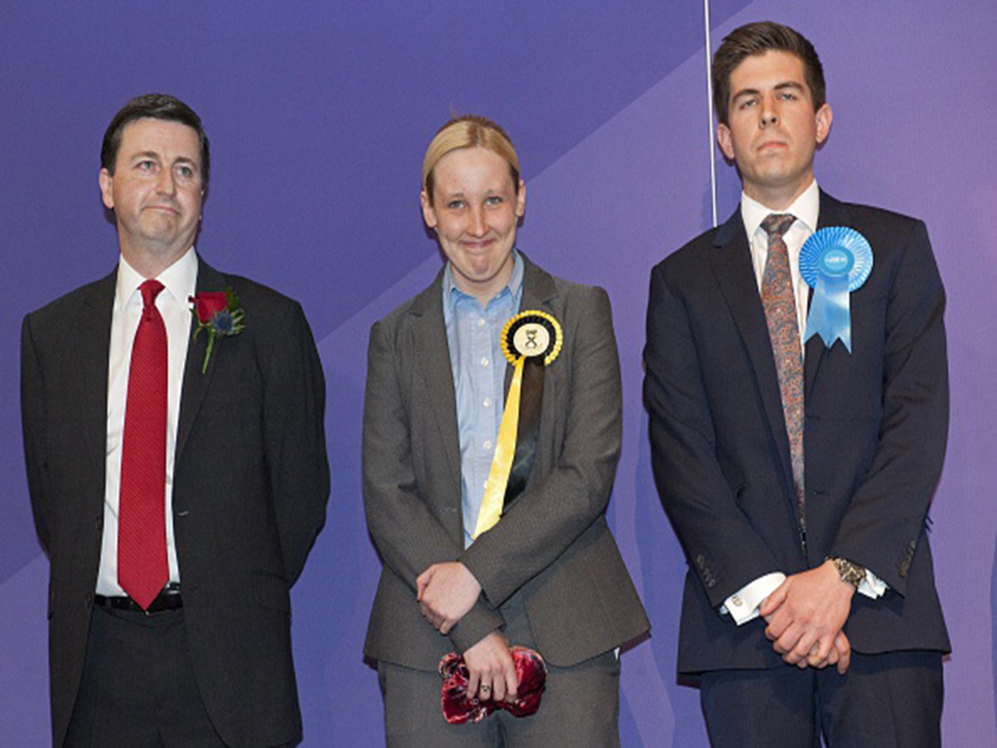 Scottish National Party (SNP) member of parliament, Mhairi Black (C), stands with Labour candidate Douglas Alexander (L) and Fraser Galloway, Conservative Candidate