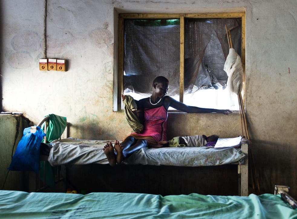A mother watches over her baby suffering from malaria in South Sudan