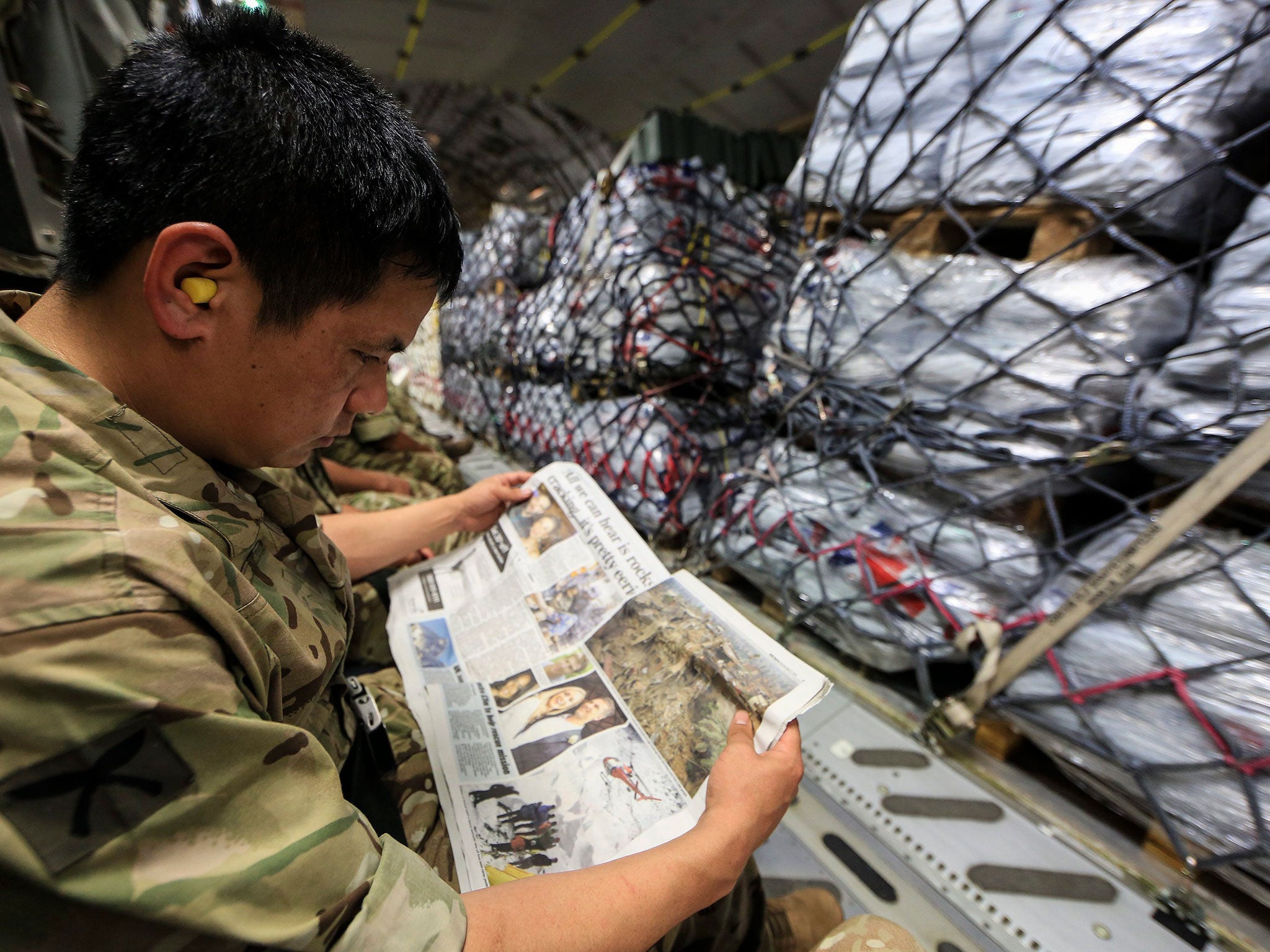 A Gurkha on an RAF plane heading for Kathmandu with British aid last month