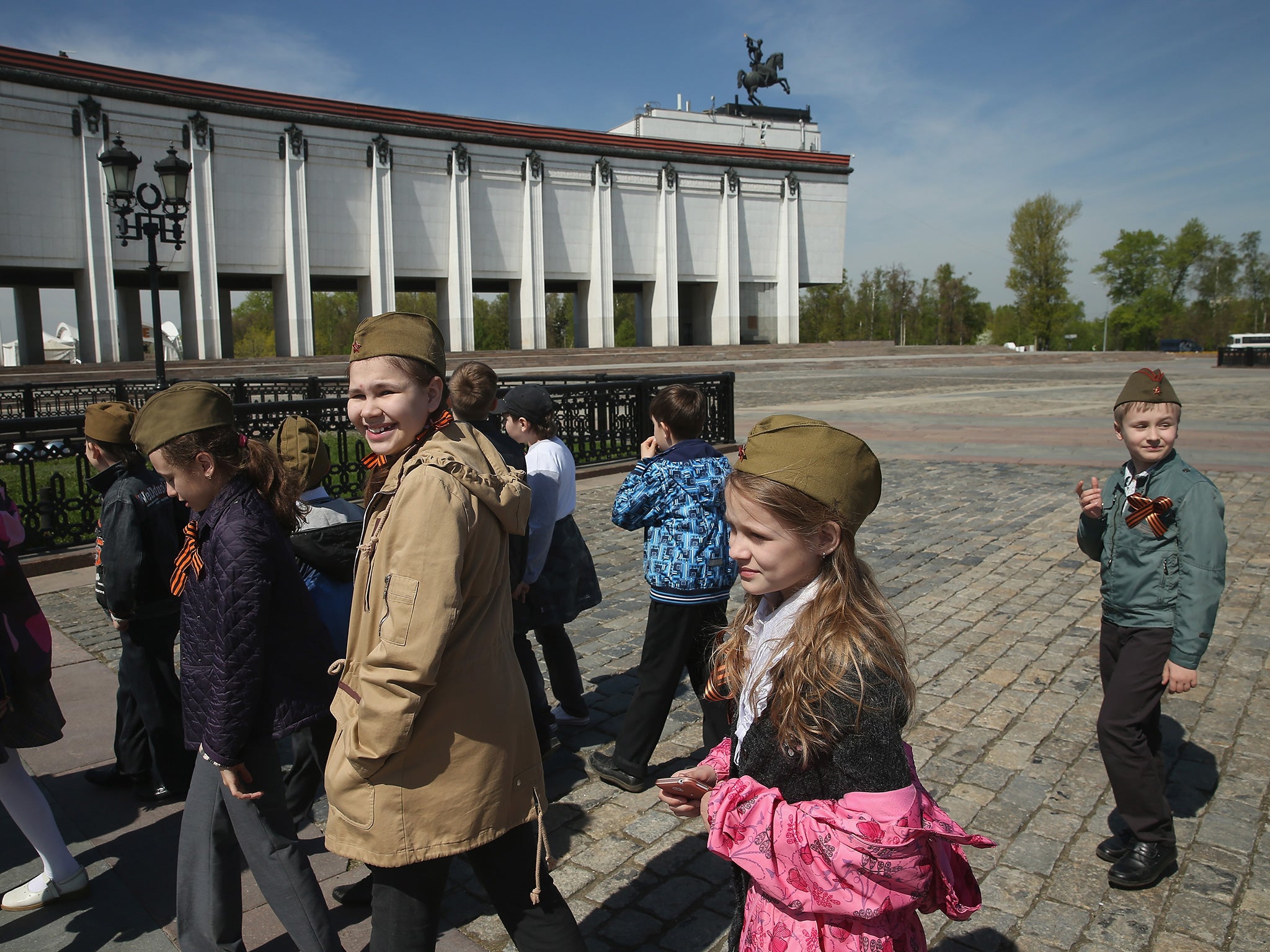 Children wear Red Army caps