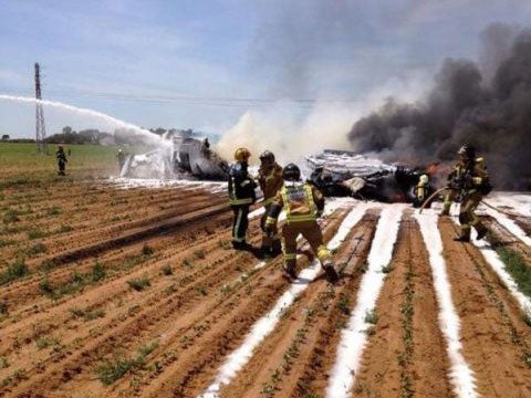 Firemen trying to extinguish the flames after a Airbus A400 military plane crashed near Seville on 9 May