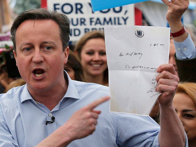 British Prime Minister David Cameron holds up a letter from former Labour Treasury Minister Liam Byrne during the 2015 election campaign