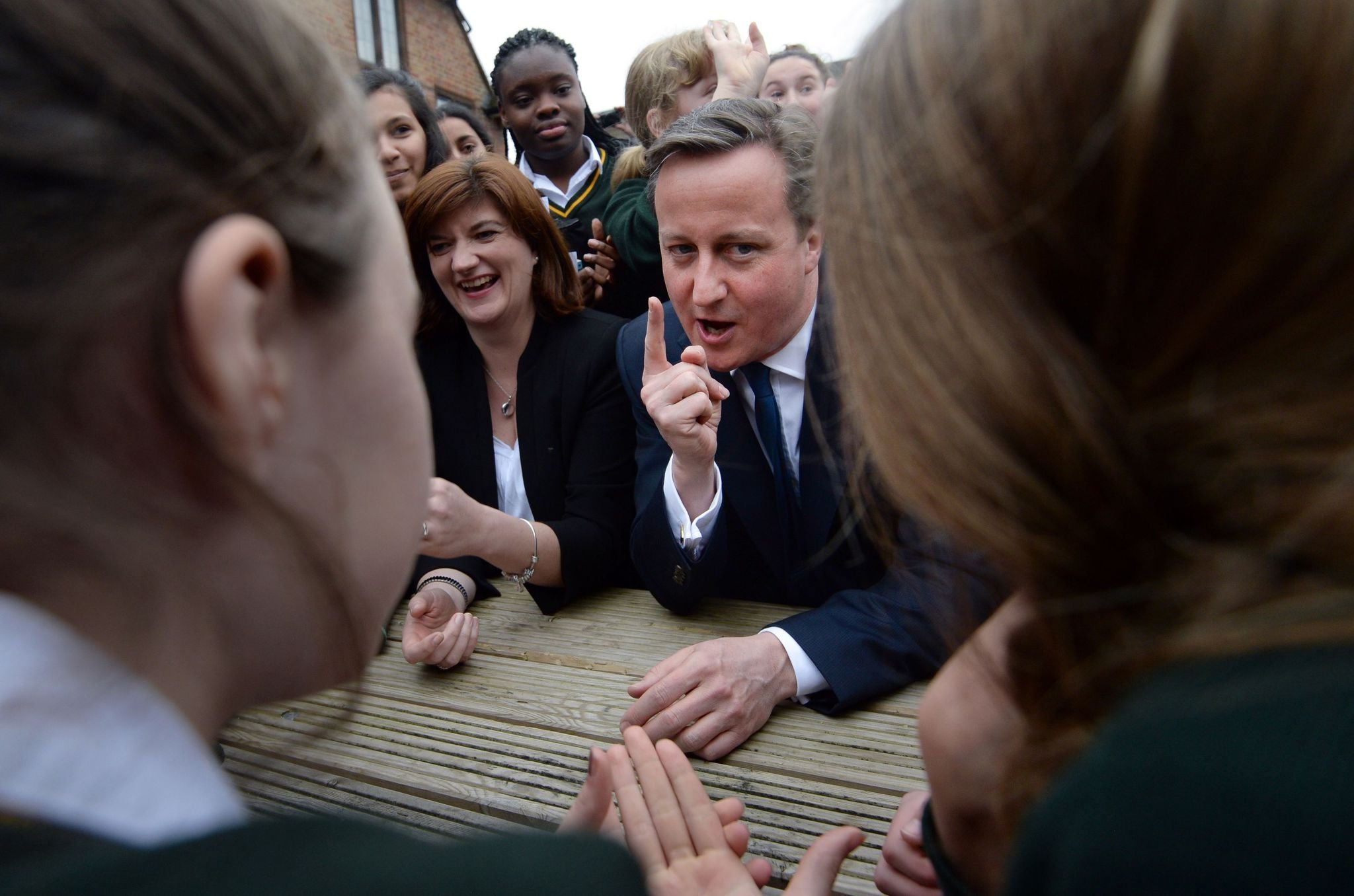 Education secretary Nicky Morgan and Prime Minister David Cameron meet pupils at a London school after announcing their pledge to open 500 more free schools over the course of the next parliament.