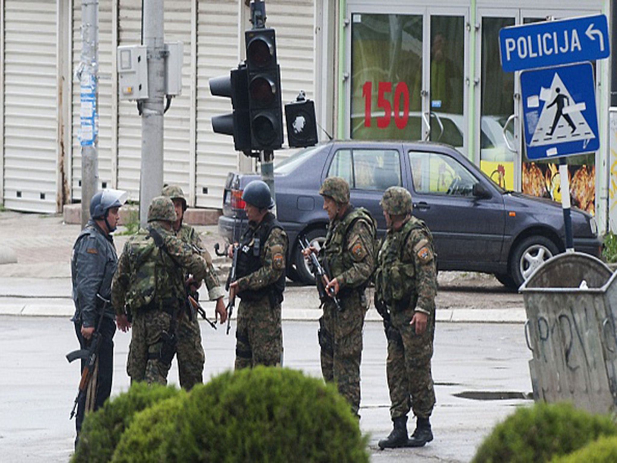 Police officers patrol in the streets of Kumanovo after armed incidents