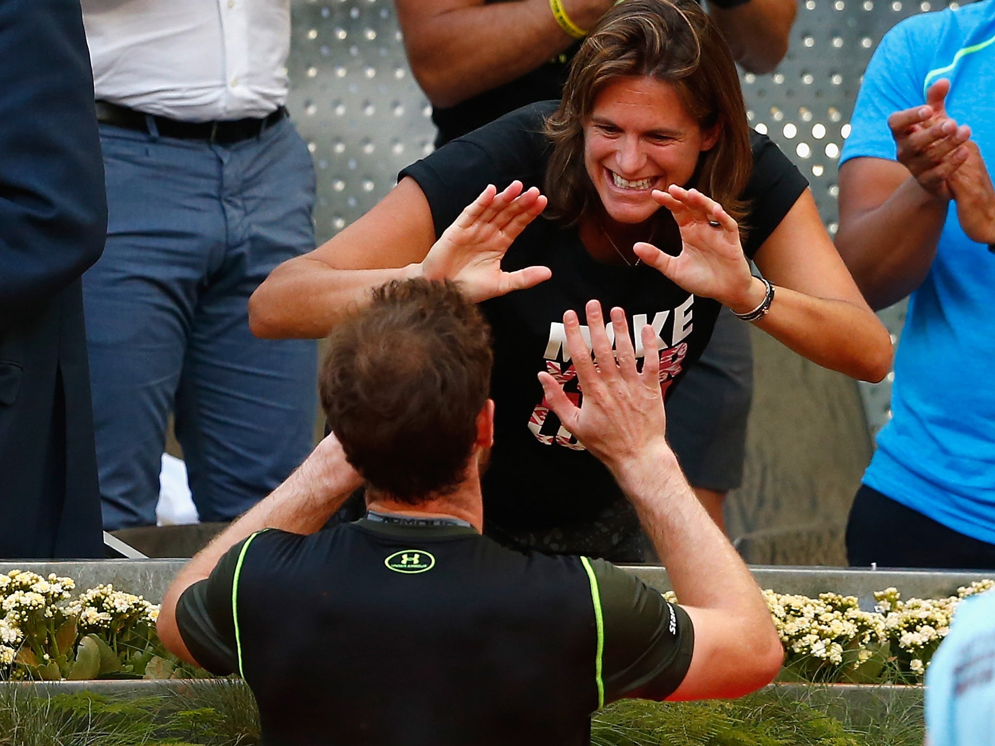 A delighted Andy Murray celebrates with his coach, Amélie Mauresmo, after taking the title in Madrid