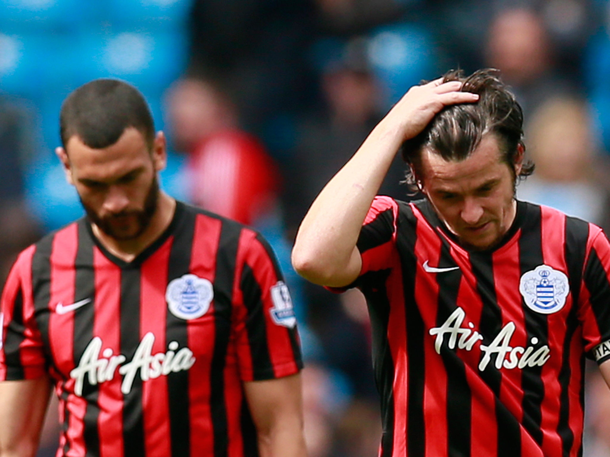 Steven Caulker and Joey Barton hang their heads after QPR are relegated from the Premier League