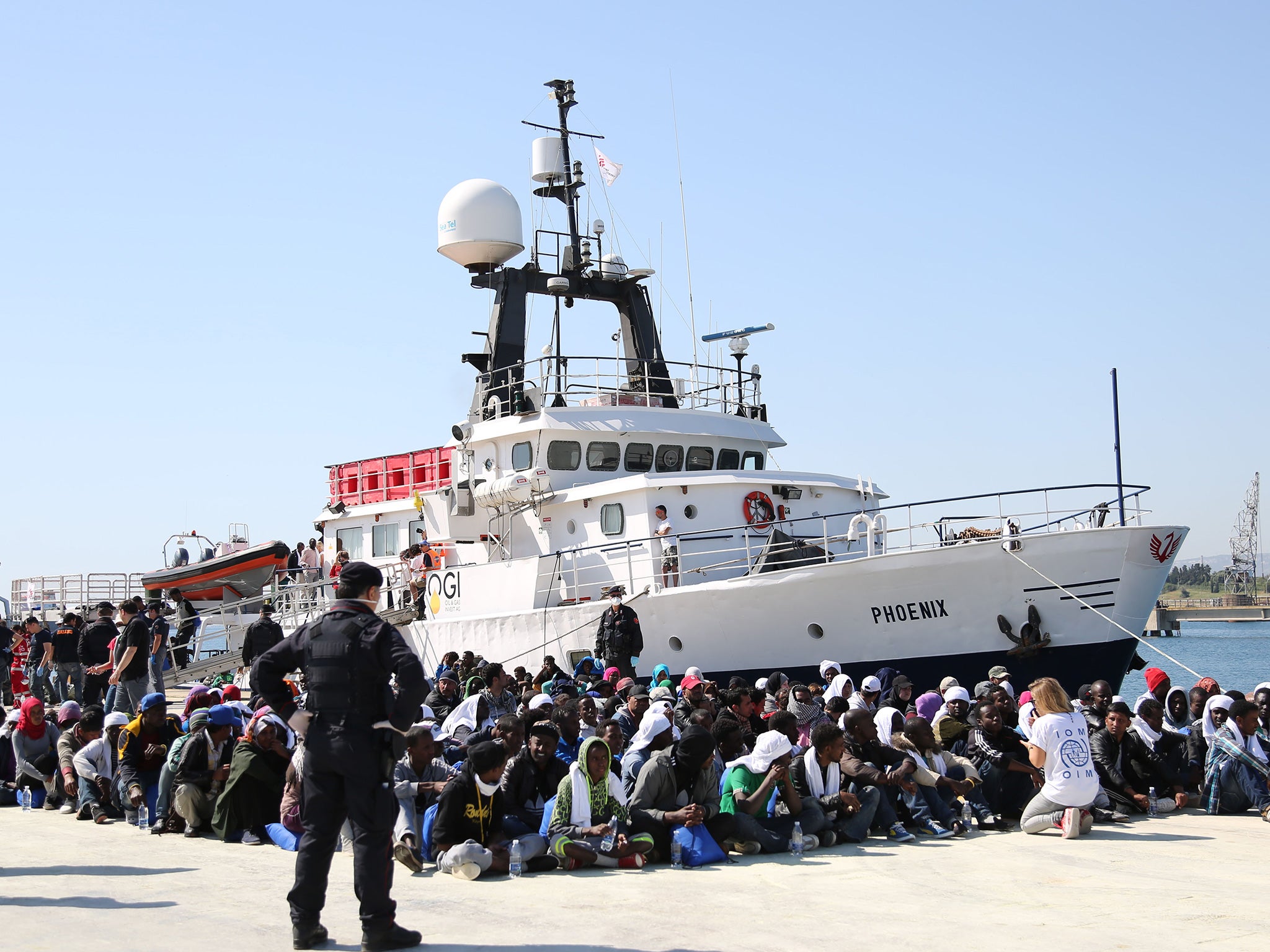 Migrants land in the harbour at Augusta, Sicily. The EU Commission is trying to devise a quota system obliging countries to share the burden of settling refugees