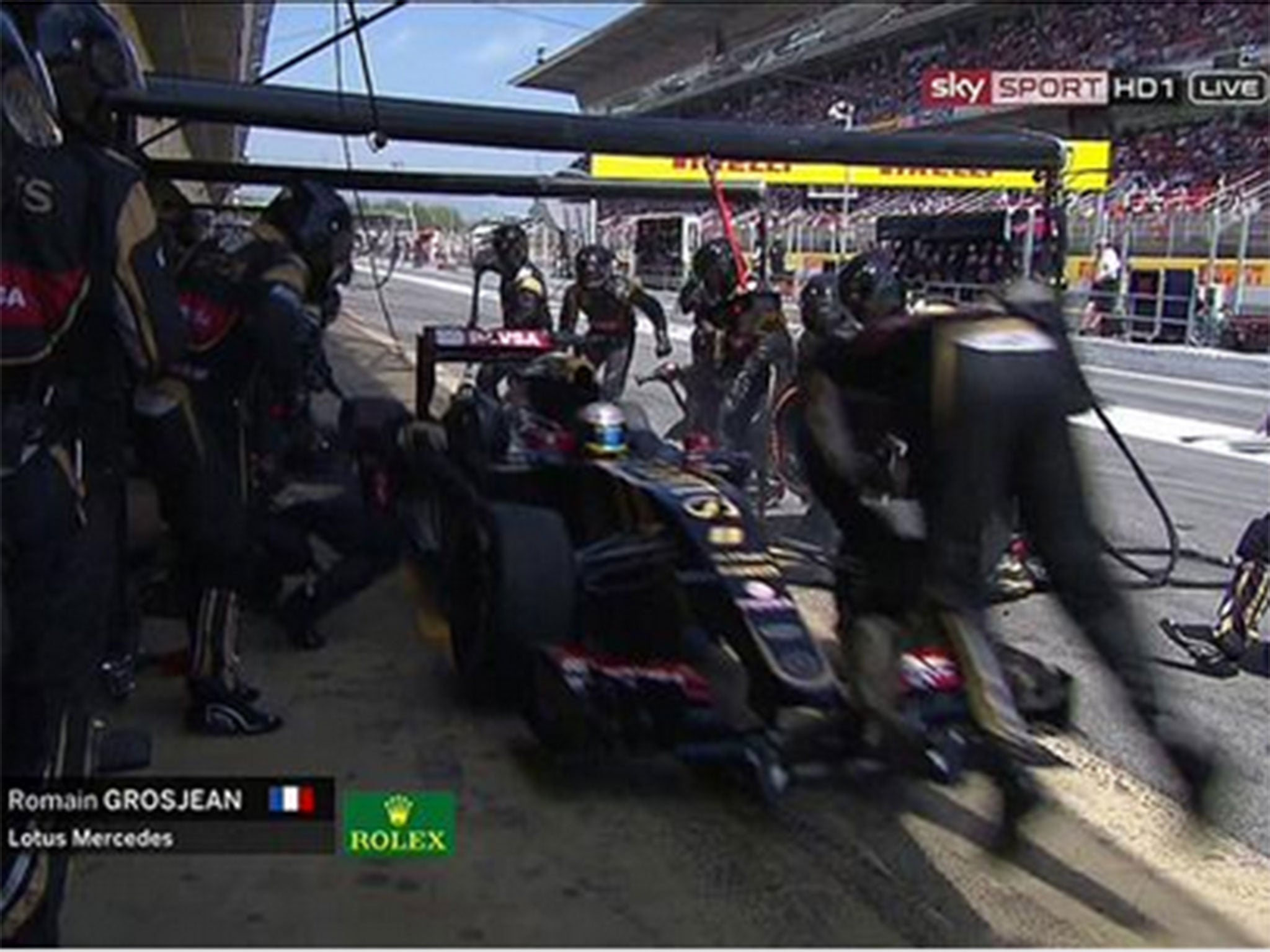 A mechanic is flung in the air after Romain Grosjean overshoots his pit box