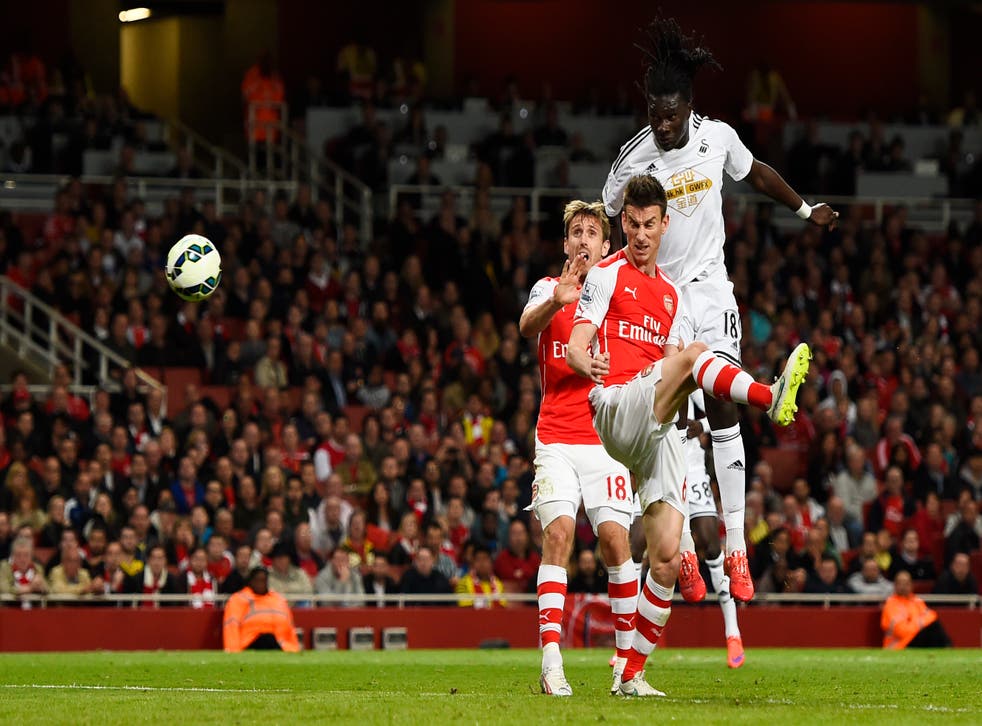 Bafetimbi Gomis rises above Laurent Koscielny to head home Swansea’s late winner at the Emirates