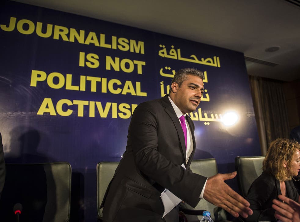 Egyptian-Canadian journalist Mohamed Fahmy, formerly with Al-Jazeera, is greeted by an unknown man duting a press conference in Cairo on May 11, 2015. Fahmy, who was sentenced last year to up to 10 years in prison, has sued his Qatari employer for $100 mi