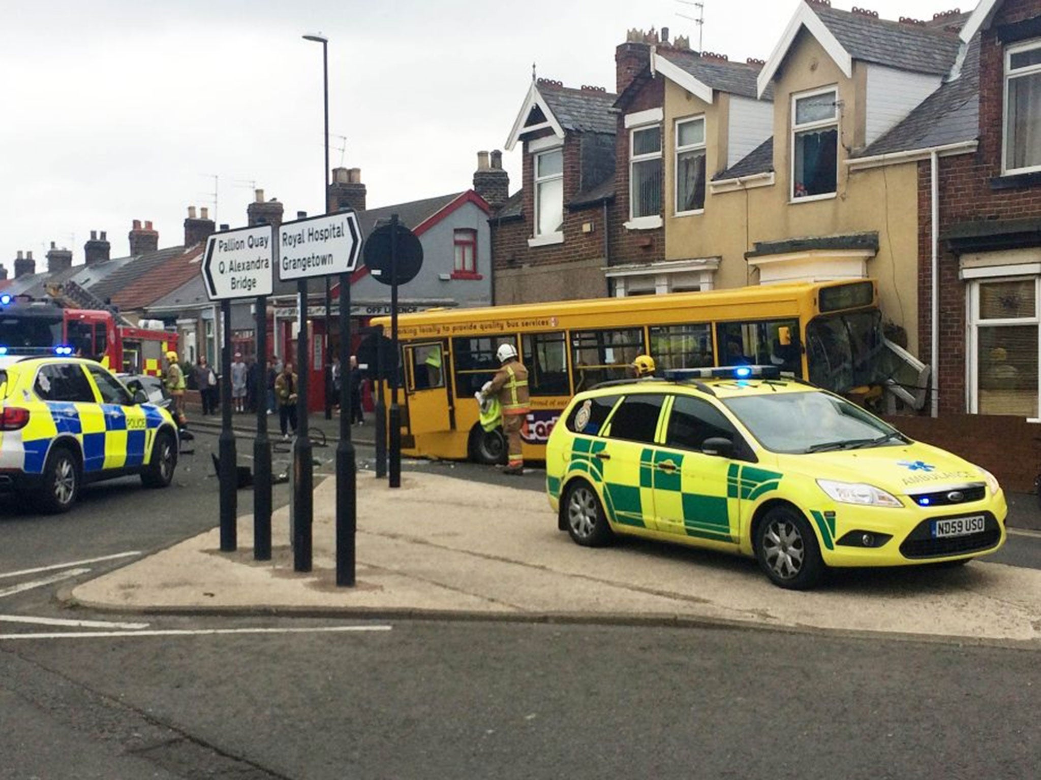 Handout photo courtesy of Kev Atkinson of the scene of a bus crash in Merle Terrace, Pallion, Sunderland, after a yellow single-decker hit a house near a junction. PRESS ASSOCIATION Photo. Picture date: Tuesday May 12, 2015. People escaped with minor inju