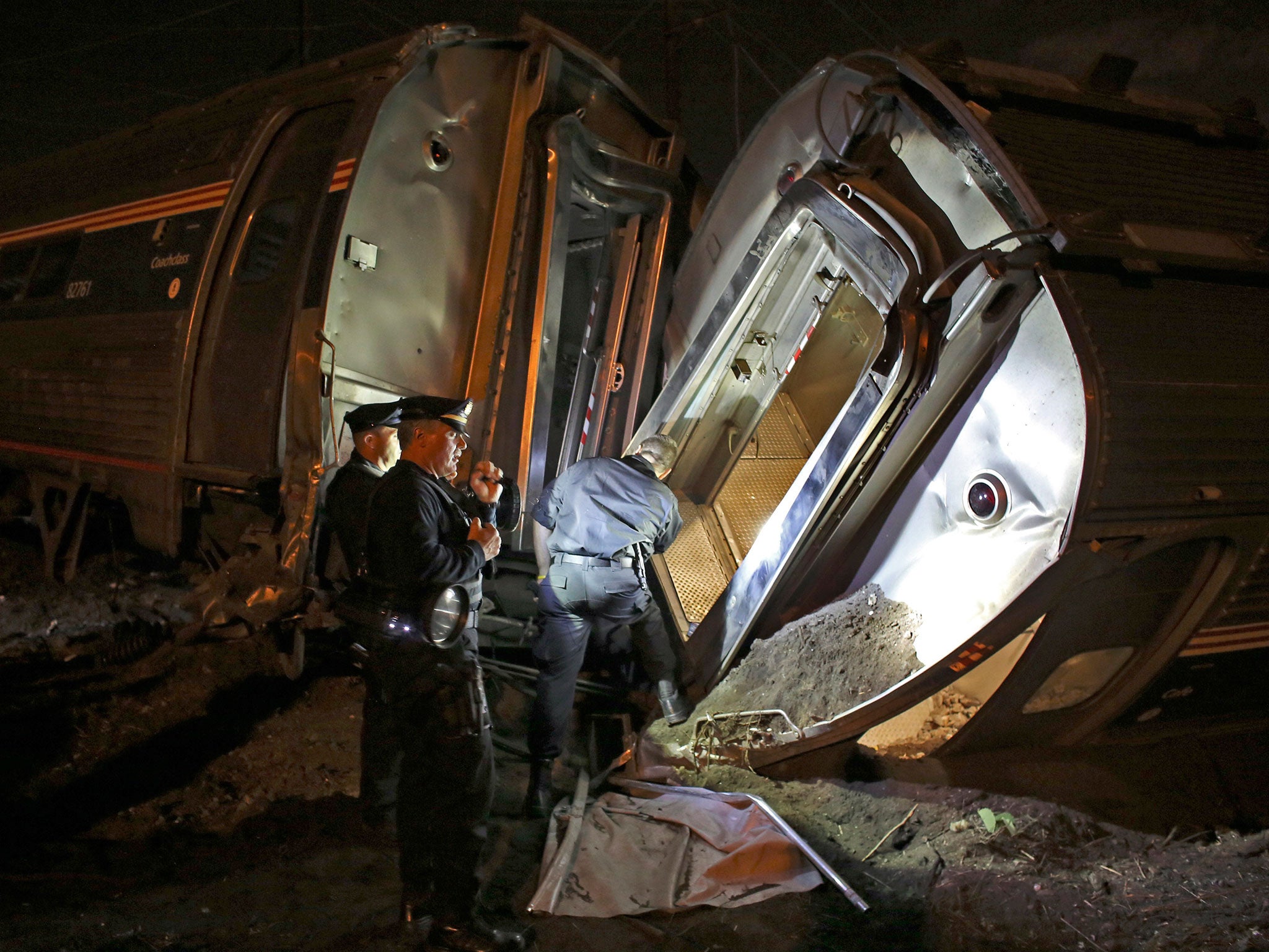 Emergency personnel inspect the train wreck