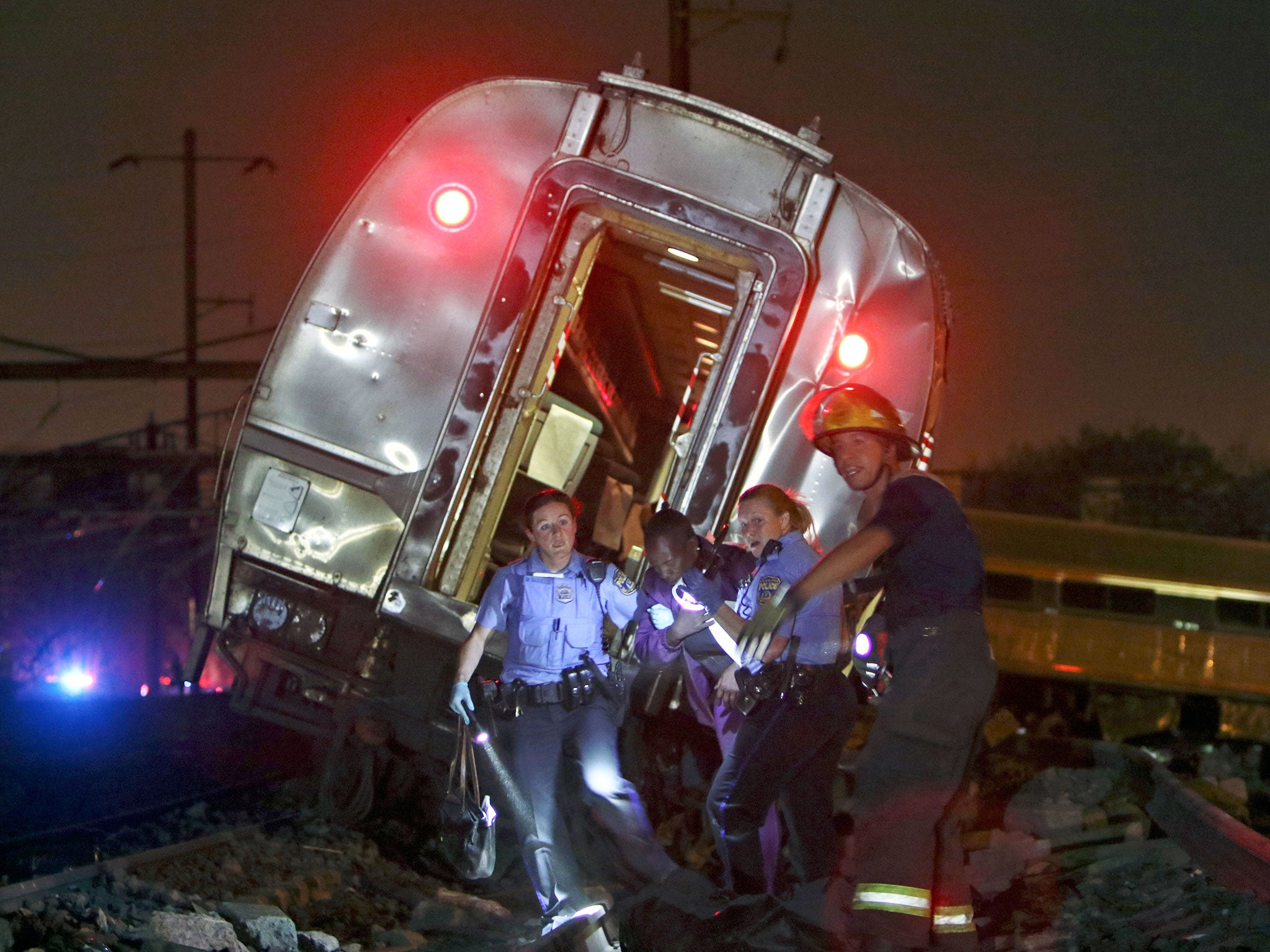 Emergency personnel work the scene of a deadly train wreck