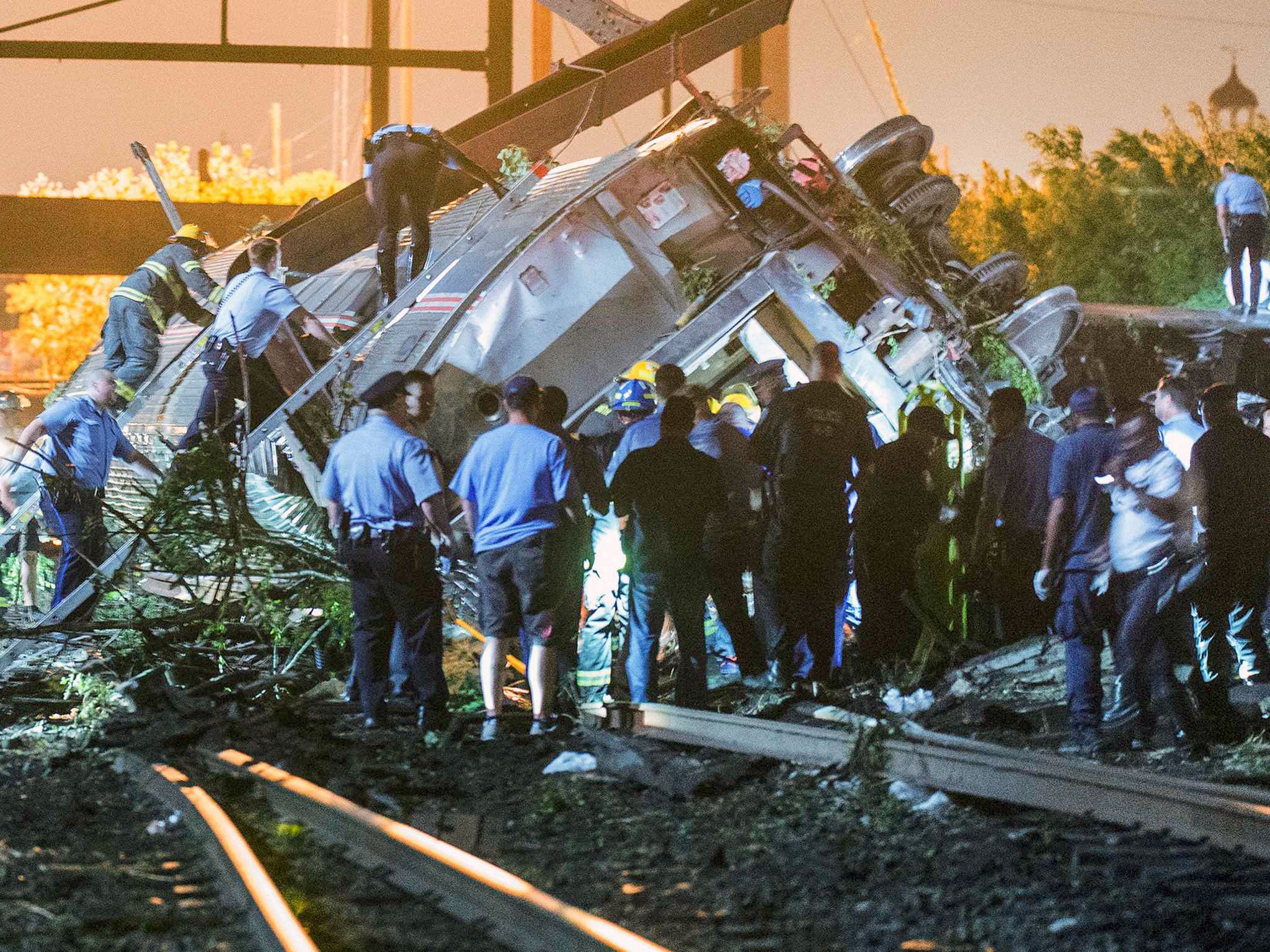 Emergency responders search for passengers following an Amtrak train derailment in the Frankfort section of Philadelphia