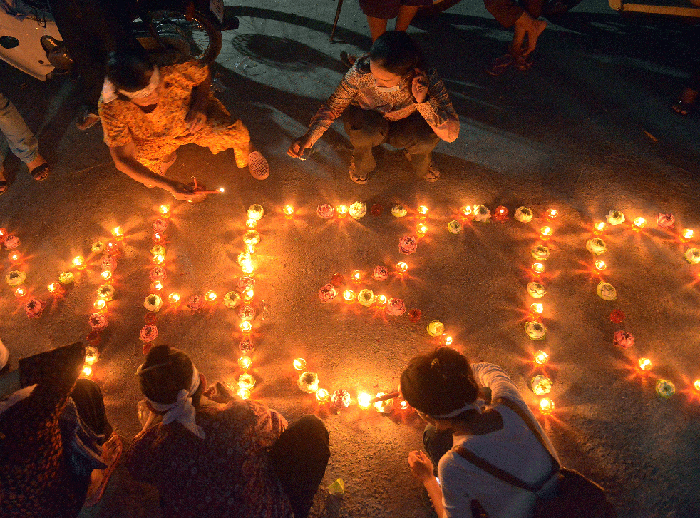 Cambodian residents of a community light candles as they pray for the missing Malaysia Airlines flight MH370 at their village in Phnom Penh on March 17, 2014