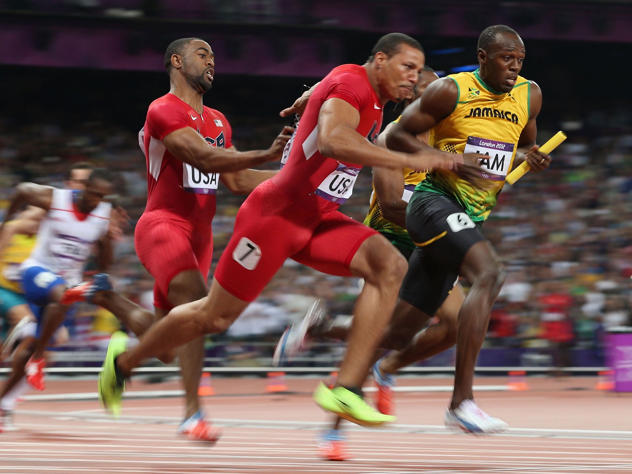 Jamaica’s Usain Bolt (right) sprints away from Ryan Bailey as Tyson Gay hands on the United States baton in the 4x100m final at London 2012
